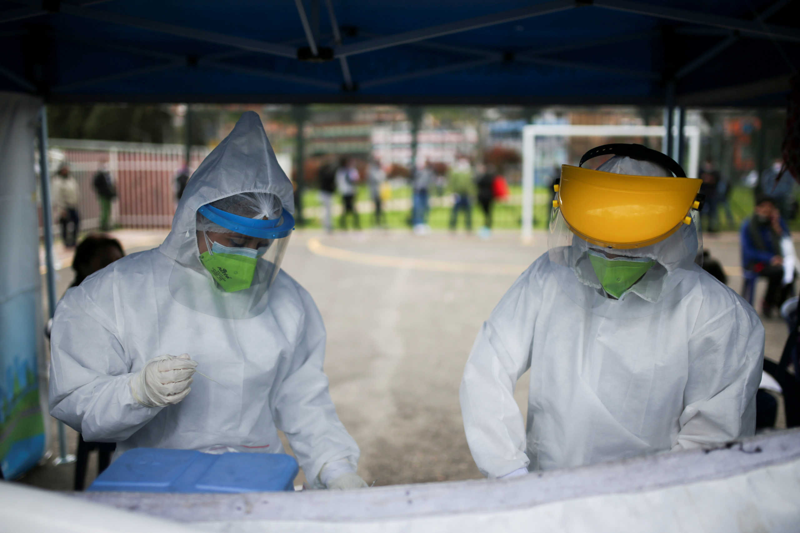 Members of the medical team prepare the items to practice tests for the coronavirus disease (COVID-19) in one of the neighbourhoods where the mayor's office decreed strict quarantine, amidst an outbreak of the coronavirus disease (COVID-19), in Bogota, Colombia July 14, 2020. REUTERS