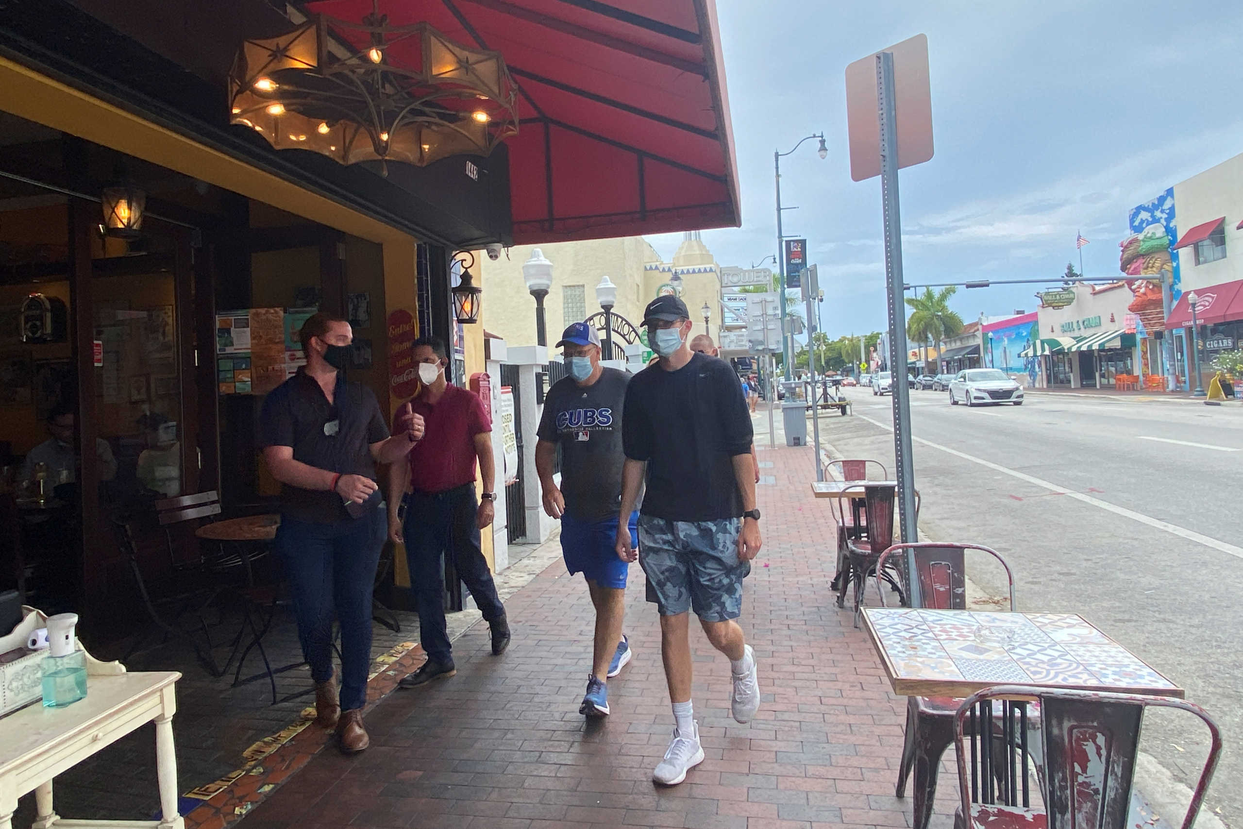 A host hands out hand sanitizer to customers entering Old's Havana Cuban Bar & Cocina ahead of Miami-Dade County's July 8 planned closures due to coronavirus disease (COVID-19) restrictions, in the Little Havana neighborhood of Miami, Florida, U.S. July 6, 2020.  REUTERS