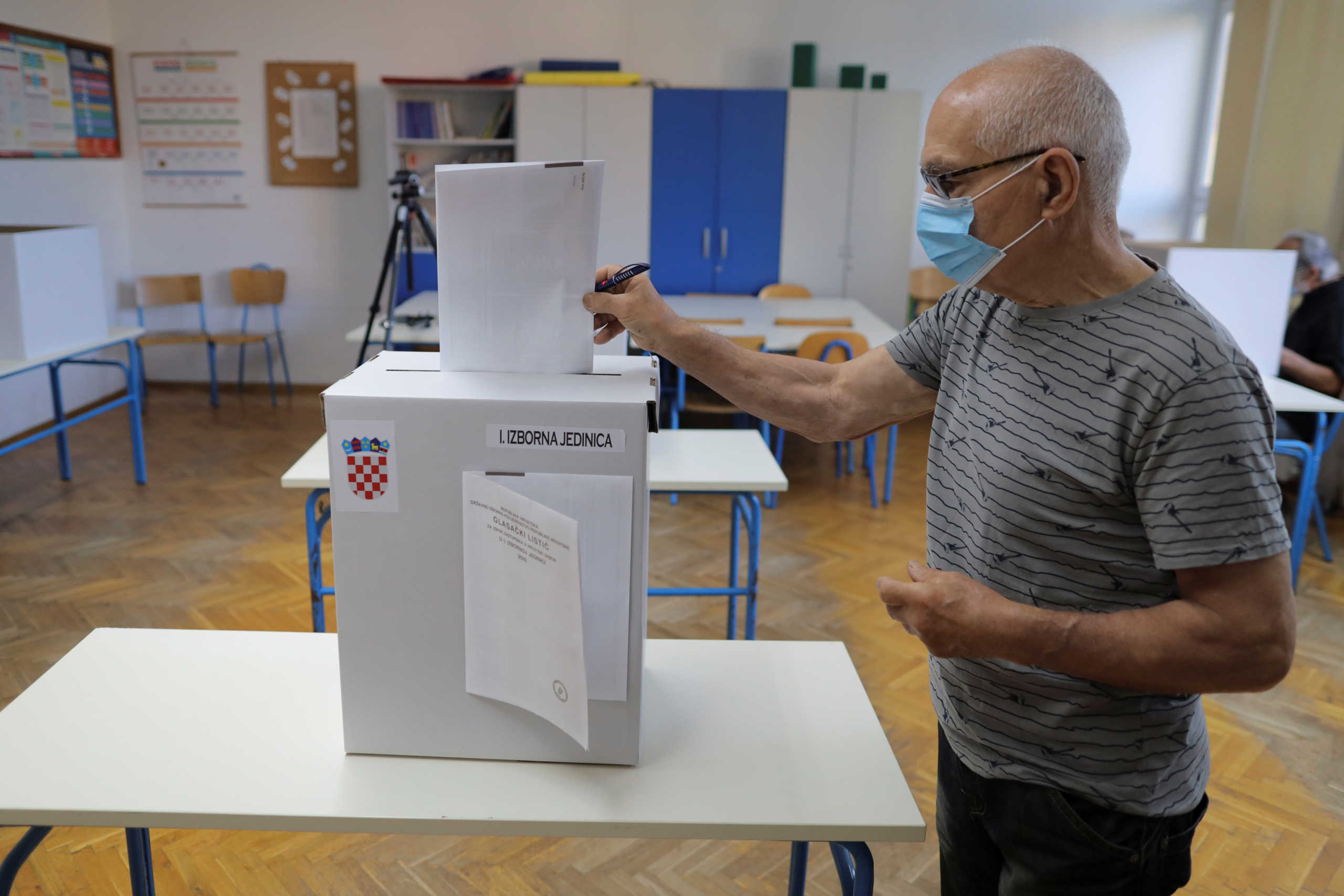 A man wearing a face mask casts his ballot during parliamentary elections, amid the spread of the coronavirus disease (COVID-19), in Zagreb, Croatia, July 5, 2020. REUTERS