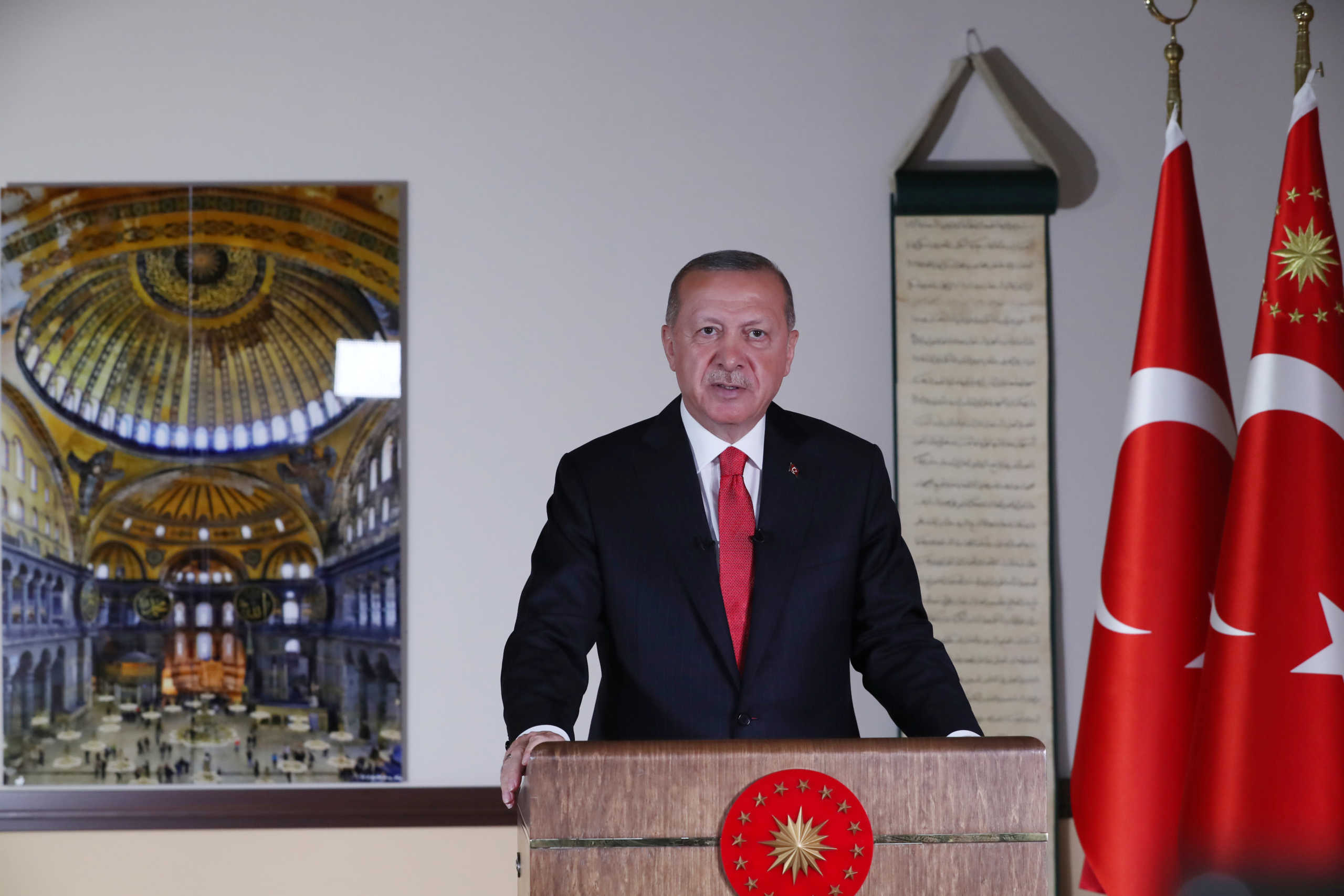 Turkish President Tayyip Erdogan, with a picture of Hagia Sophia or Ayasofya in the background, delivers a televised address to the nation in Ankara, Turkey, July 10, 2020. Turkish Presidential Press Office