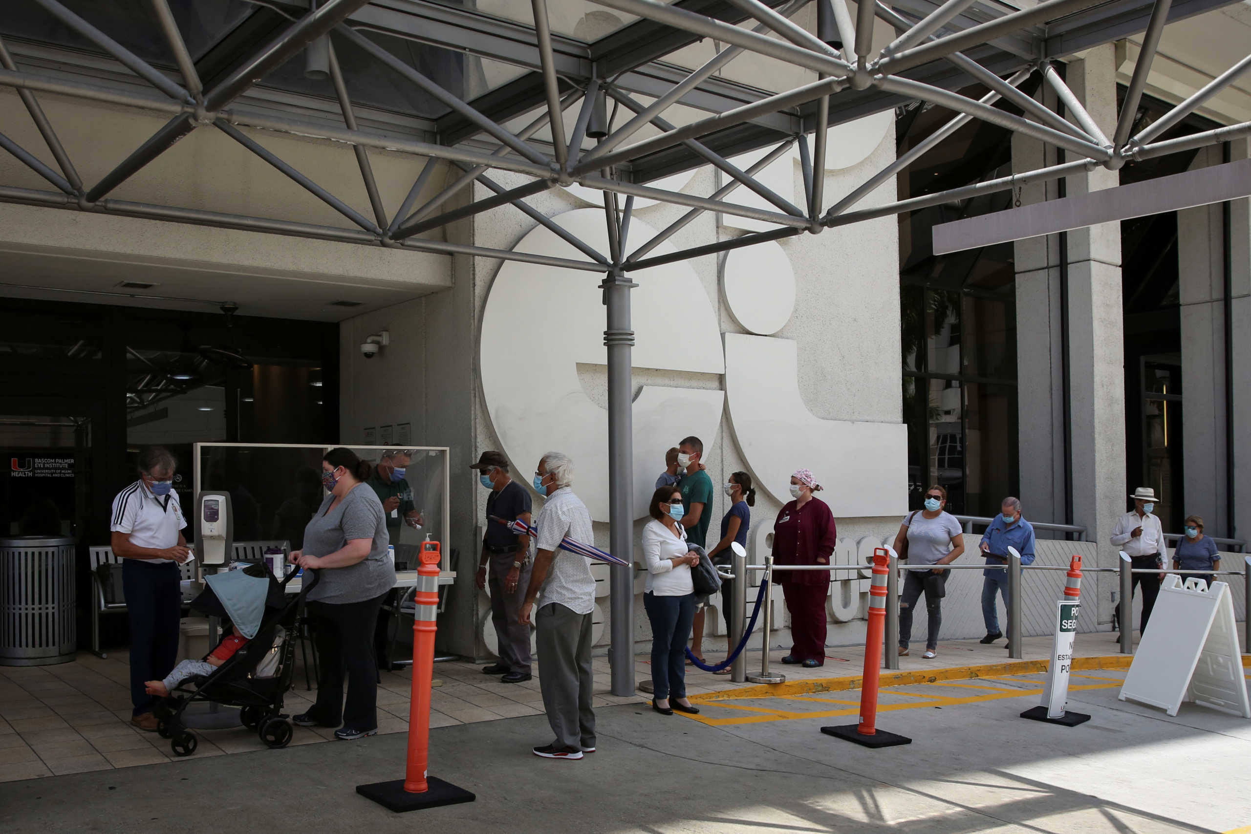 People wait for health assessment check-in before entering Jackson Memorial Hospital, as Miami-Dade County eases some of the lockdown measures put in place during the coronavirus disease (COVID-19) outbreak, in Miami, Florida, U.S., June 18, 2020. REUTERS