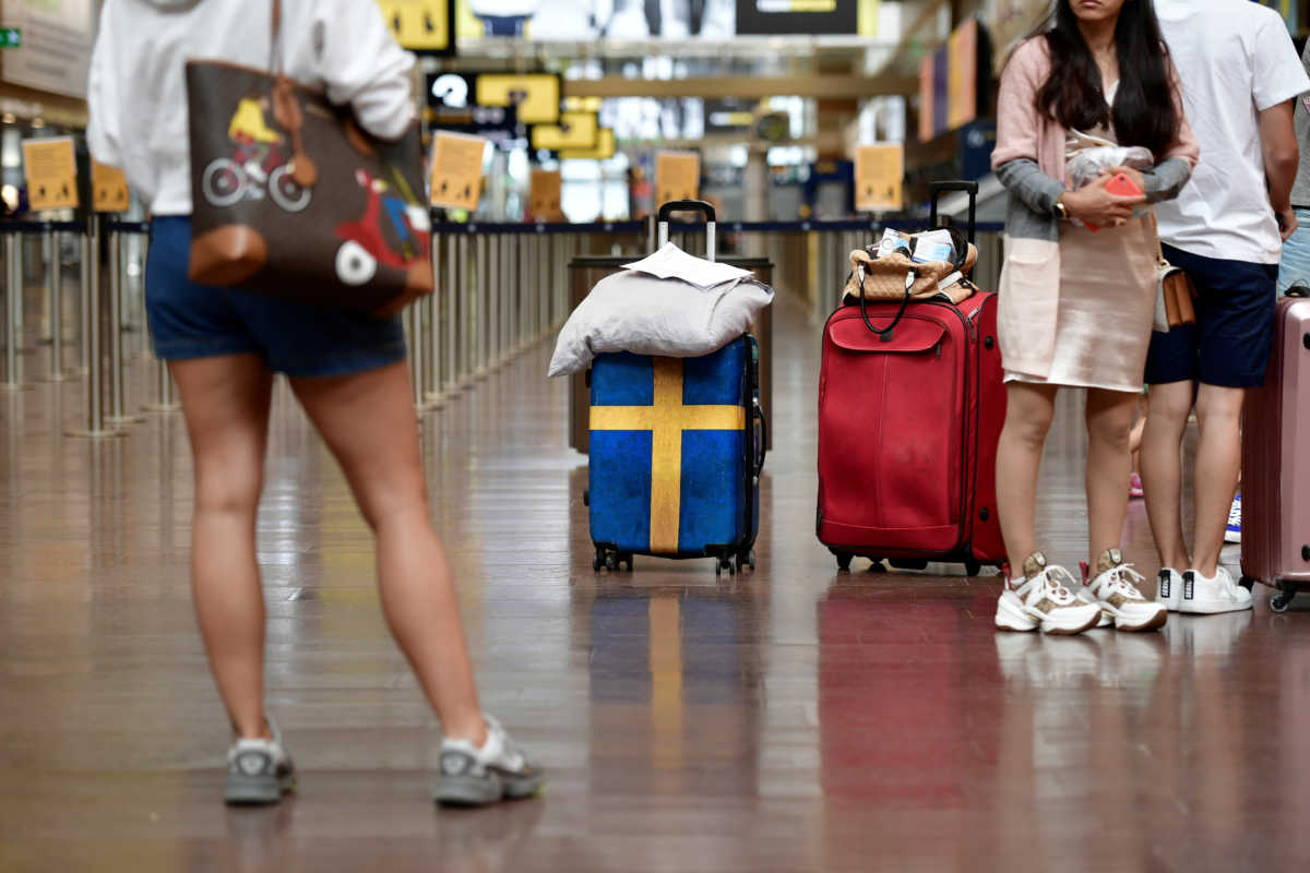 Passengers prepare to check in at Arlanda airport for the first chartered TUI flight  to Rhodes in Greece since the outbreak of the coronavirus disease (COVID-19), in Stockholm, Sweden July 2, 2020. Stina Stjernkvist