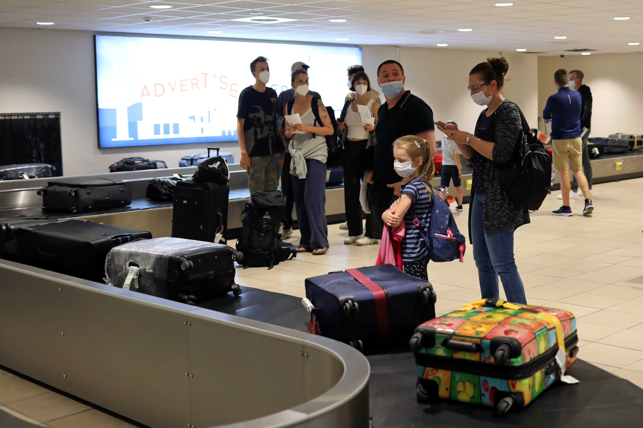 Passengers from Germany wait for the luggage as they arrive at the Rhodes International Airport after the lifting of travel restrictions following the coronavirus disease (COVID-19) outbreak, on the island of Rhodes, Greece July 1, 2020. REUTERS