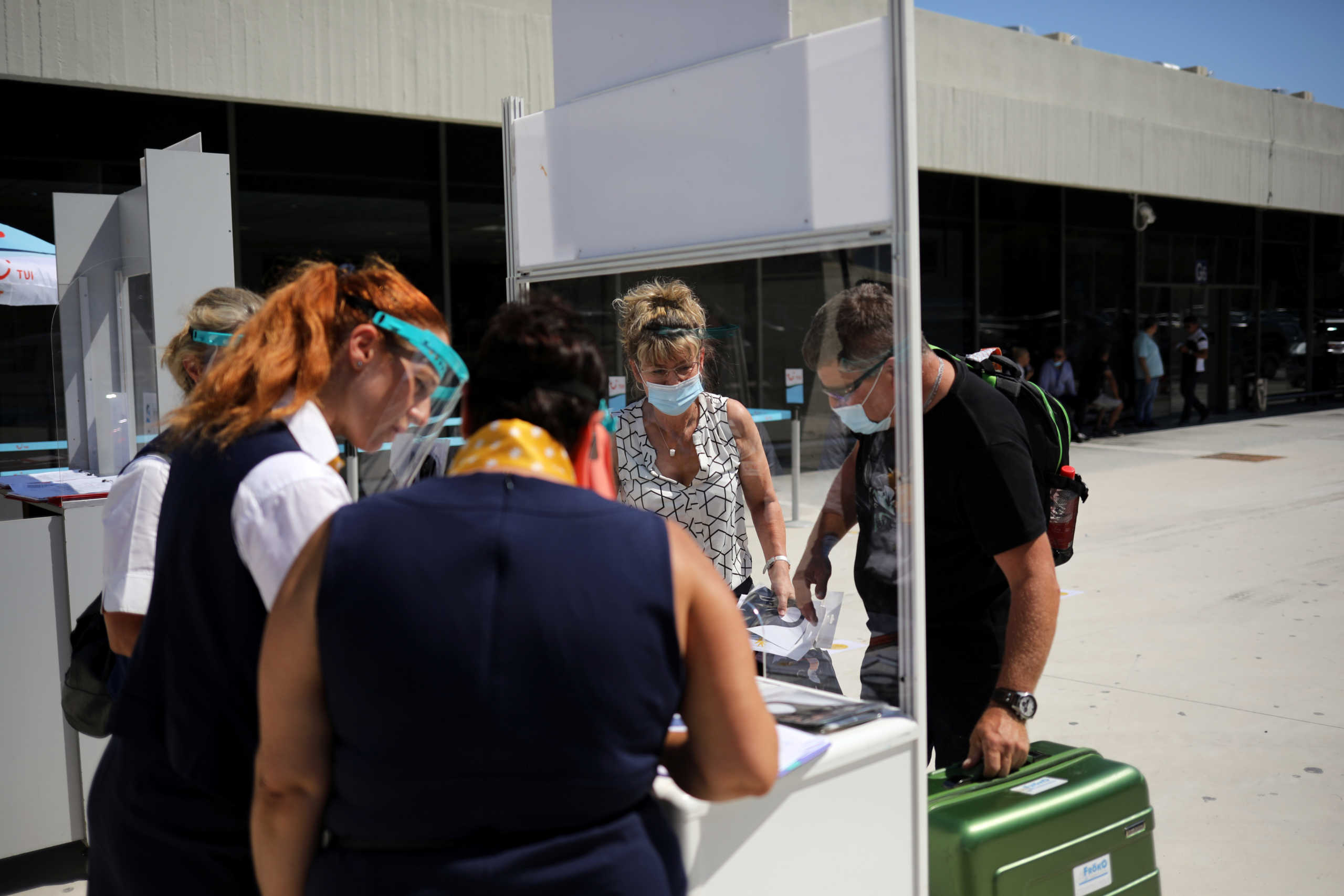 Passengers from Germany are seen outside the Rhodes International Airport after the lifting of travel restrictions following the coronavirus disease (COVID-19) outbreak, on the island of Rhodes, Greece July 1, 2020. REUTERS