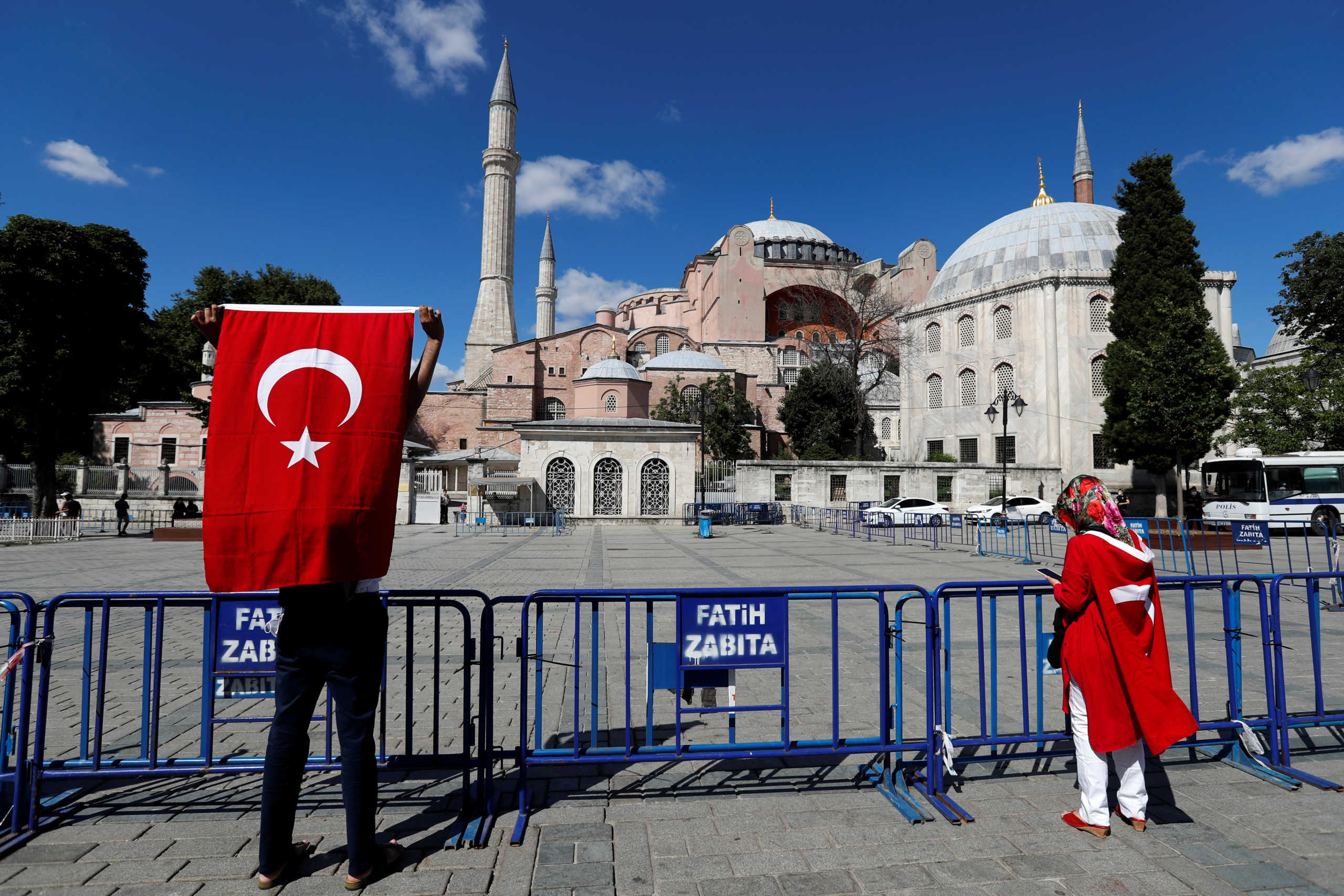 People carry Turkish flags outside the Hagia Sophia or Ayasofya, a UNESCO World Heritage Site, which was a Byzantine cathedral before being converted into a mosque and currently a museum, in Istanbul, Turkey, July 10, 2020. REUTERS