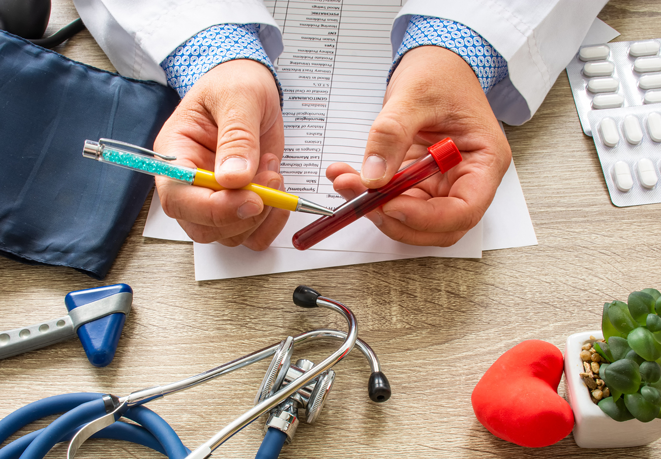 Doctor during consultation held in his hand and shows patient laboratory tube with blood. Counseling of transfusion, blood and hematologic diseases and pathology like anemias, cell cancer, hemophilia
