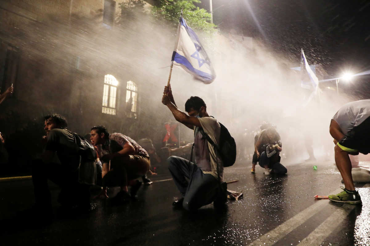 Police use water cannon as Israelis protest against Prime Minister Benjamin Netanyahu in Jerusalem July 18, 2020. REUTERS