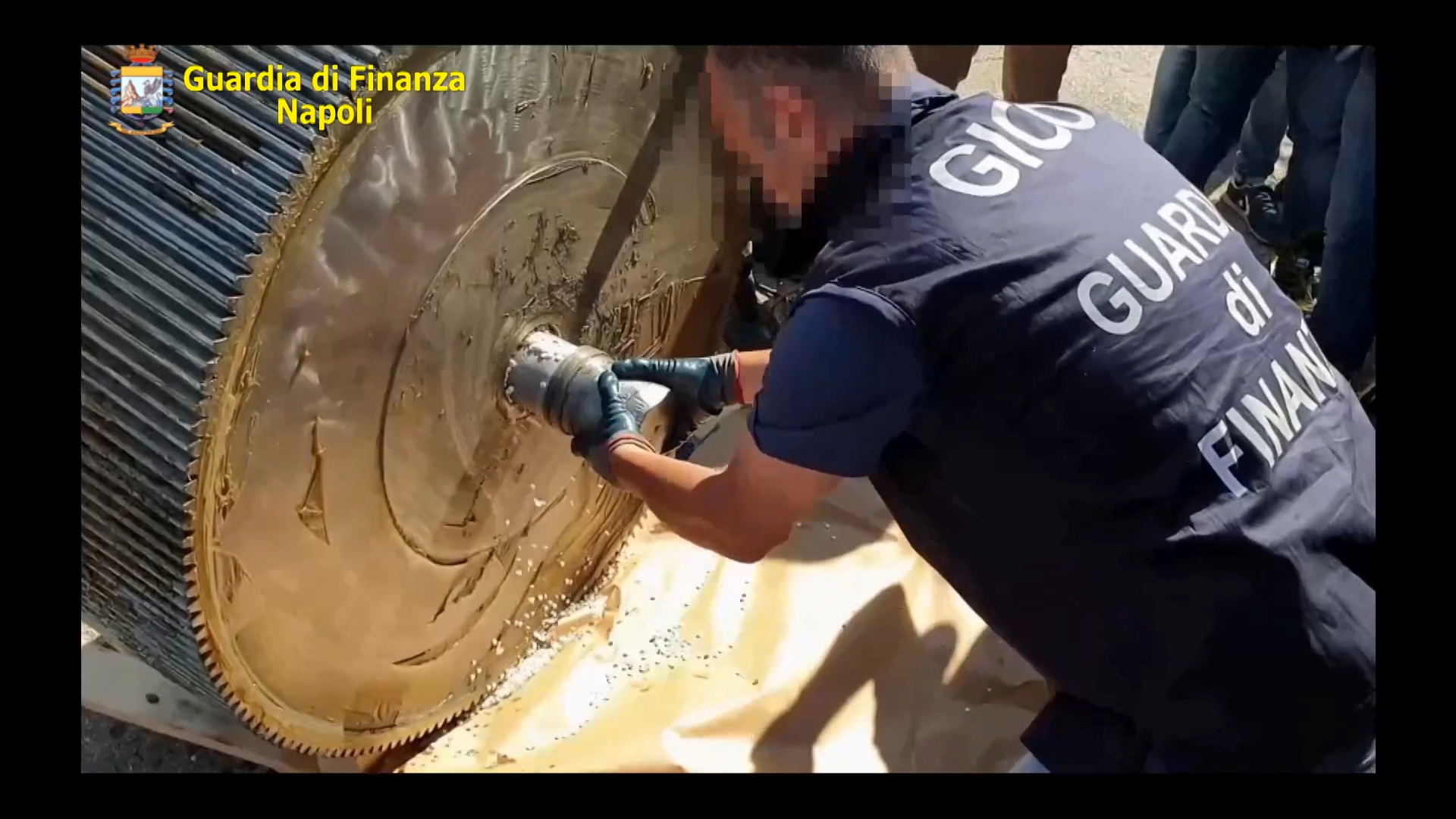 An Italian finance police officer opens a machinery containing ISIS produced amphetamine pills in this still image obtained from an undated handout video, in Salerno, Italy.  Italian Finance Police