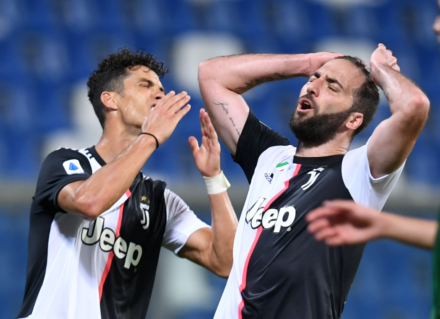 Soccer Football - Serie A - U.S. Sassuolo v Juventus - Mapei Stadium - Citta del Tricolore, Reggio Emilia, Italy - July 15, 2020   Juventus' Cristiano Ronaldo and Gonzalo Higuain react, as play resumes behind closed doors following the outbreak of the coronavirus disease (COVID-19)   REUTERS