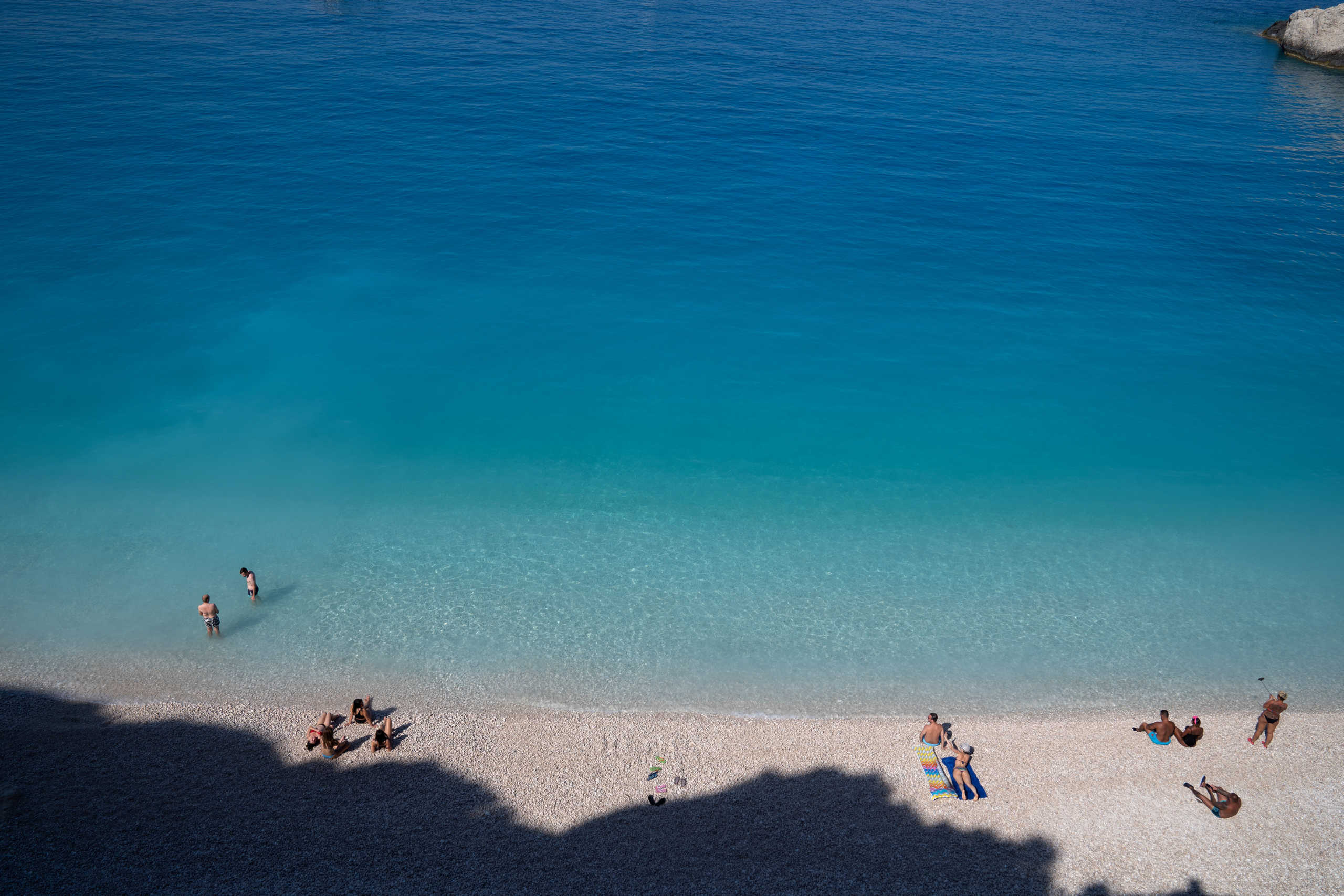 People visit Porto Katsiki beach, following the easing of measures against the spread of the coronavirus disease (COVID-19), on the island of Lefkada, Greece, July 25, 2020. Picture taken July 25, 2020. REUTERS