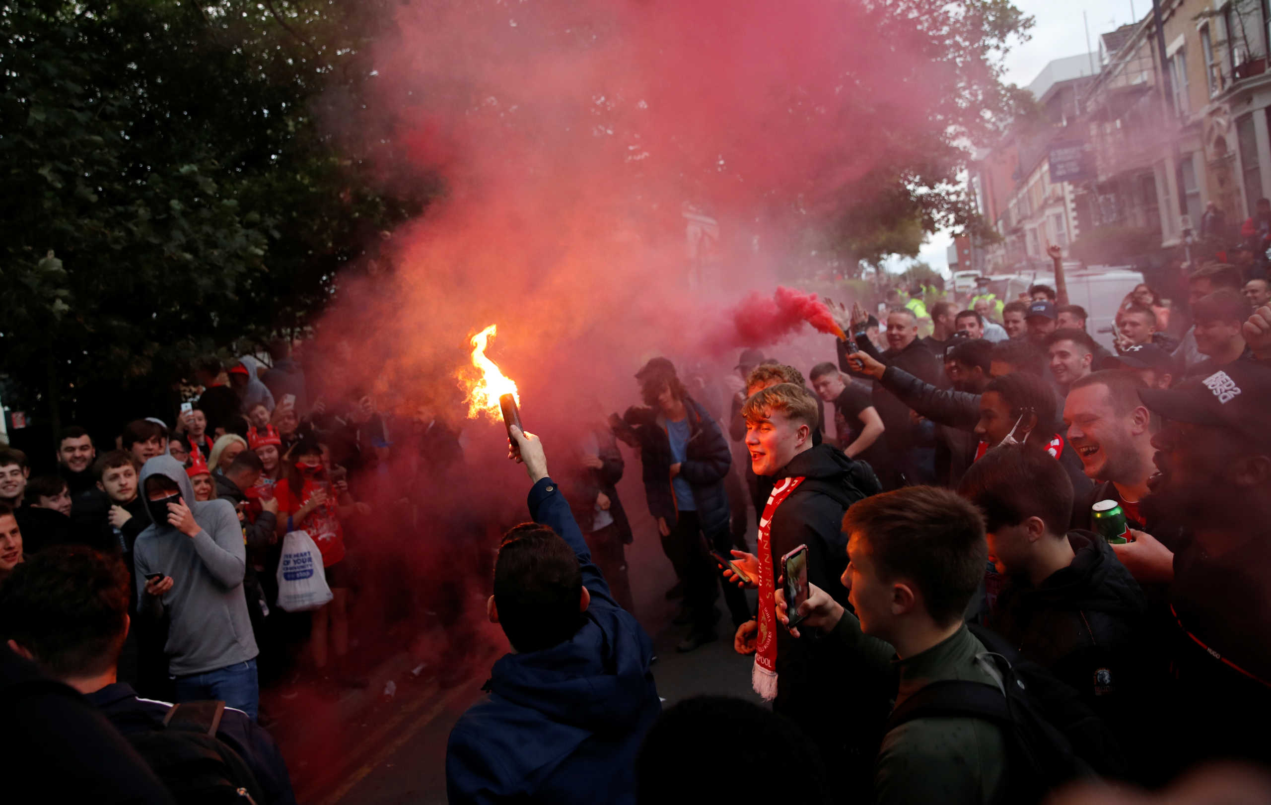 Soccer Football - Premier League - Liverpool v Chelsea - Anfield, Liverpool, Britain - July 22, 2020  Liverpool fans with flares outside the stadium during the match  Action Images via Reuters
