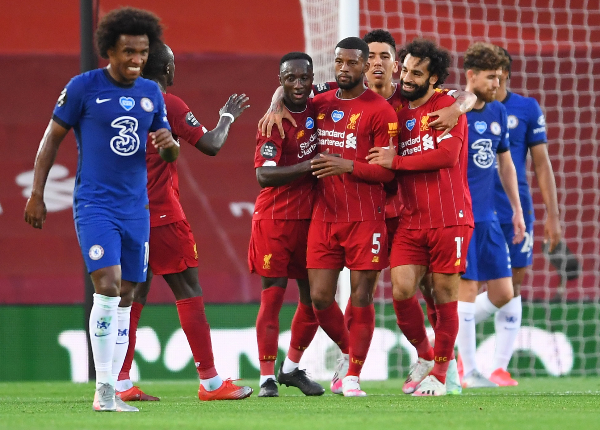 Soccer Football - Premier League - Liverpool v Chelsea - Anfield, Liverpool, Britain - July 22, 2020 Liverpool's Georginio Wijnaldum celebrates scoring their third goal with teammates, as play resumes behind closed doors following the outbreak of the coronavirus disease (COVID-19) Pool via REUTERS