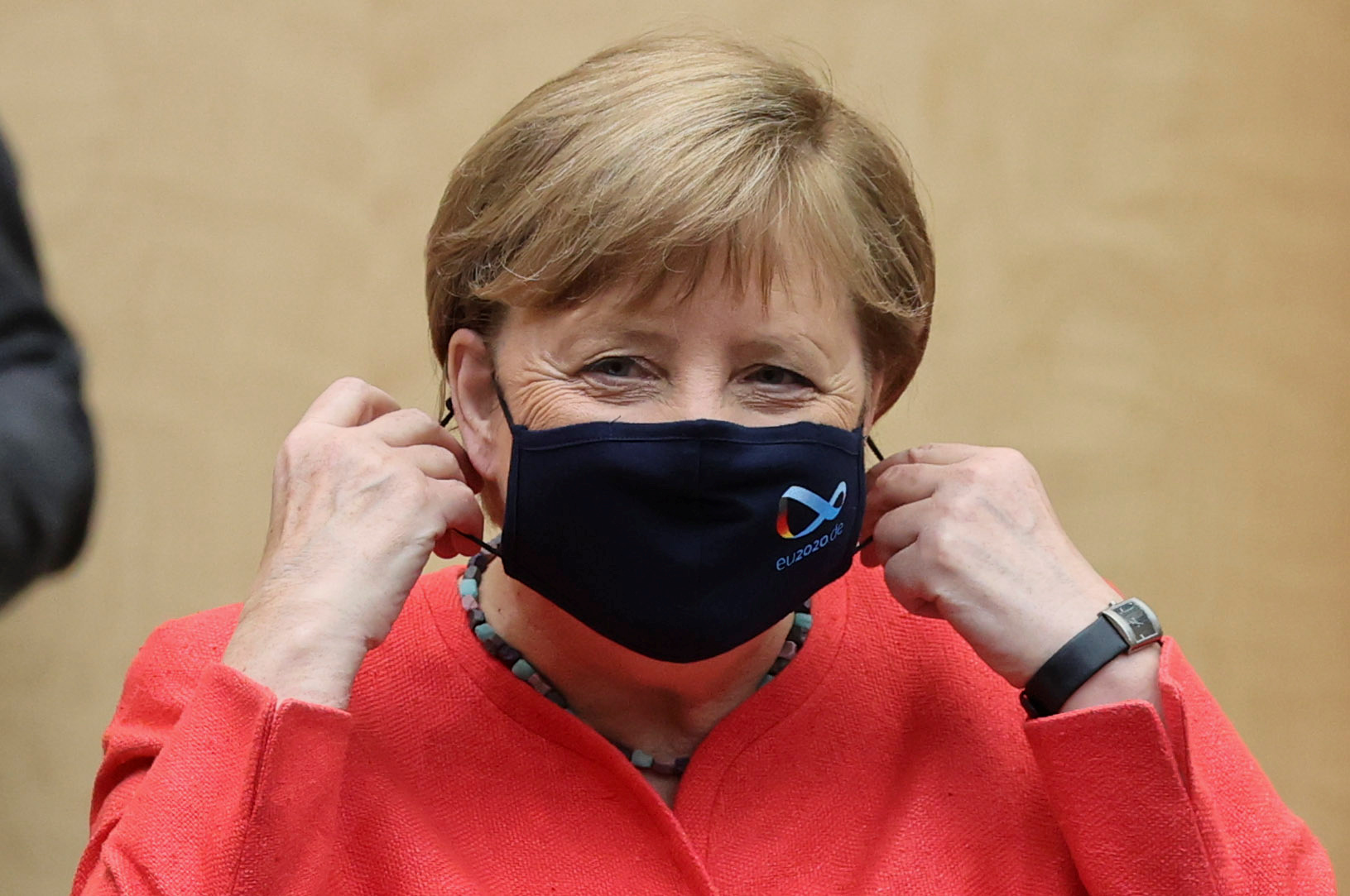 German Chancellor Angela Merkel takes off her face mask during a session at the upper house of the German parliament Bundesrat, following the outbreak of the coronavirus disease (COVID-19), in Berlin, Germany, July 3, 2020. REUTERS