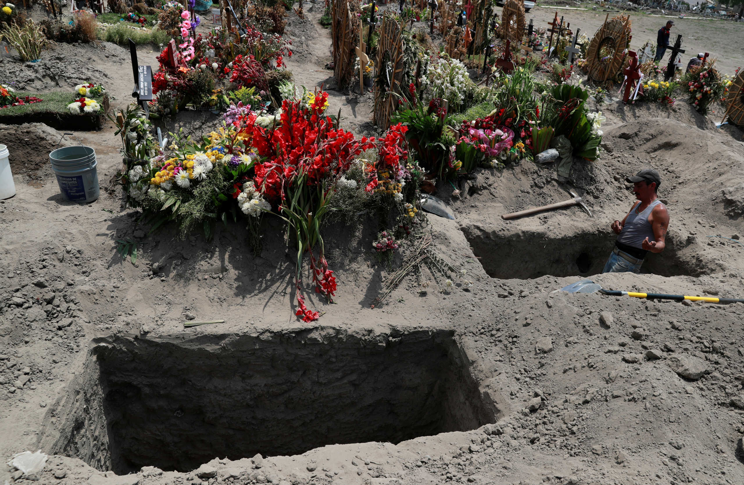 A man digs a grave at the Xico cemetery, as the coronavirus disease (COVID-19) outbreak continues, in Valle de Chalco, in the State of Mexico,, Mexico, Mexico June 29, 2020. REUTERS