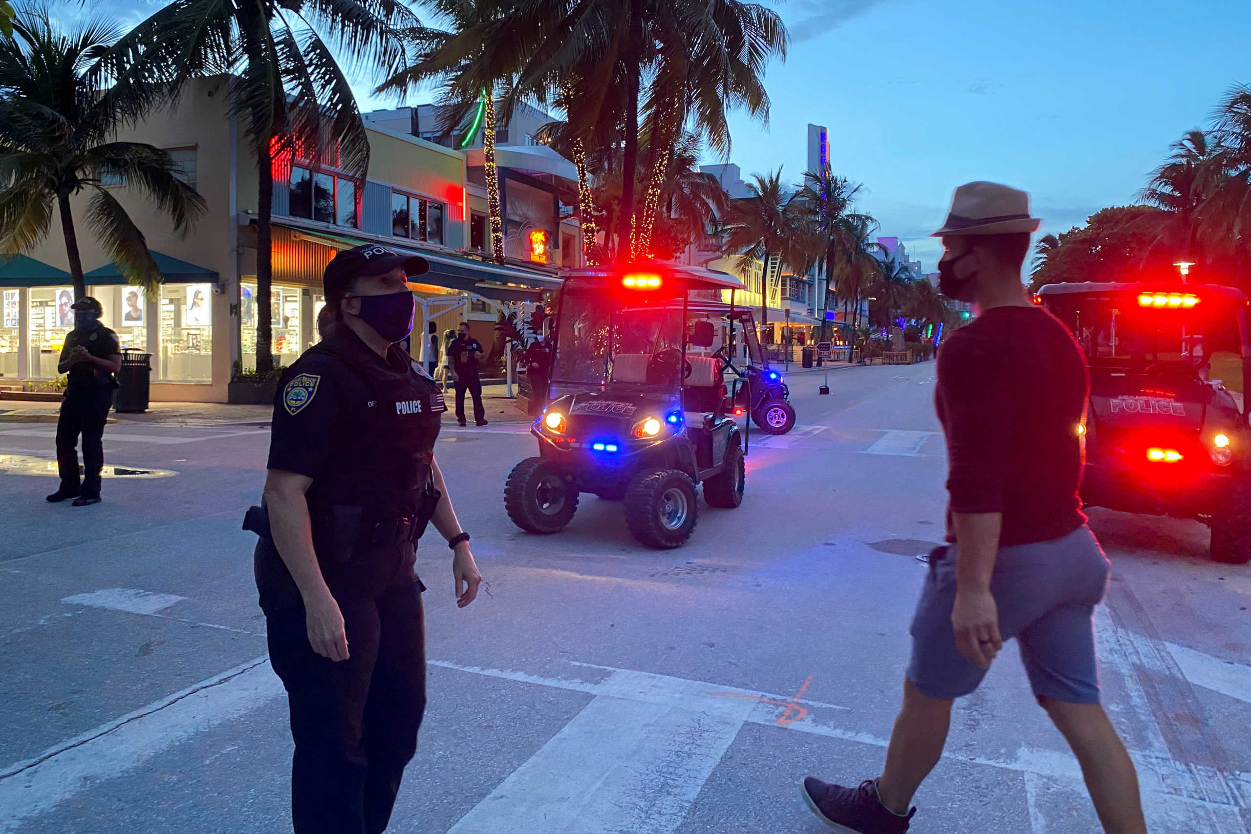 Police officers maintain the 8 pm curfew, imposed due to Florida's climbing numbers of coronavirus disease (COVID-19) cases, in Miami Beach, Florida, U.S. July 18, 2020.  REUTERS