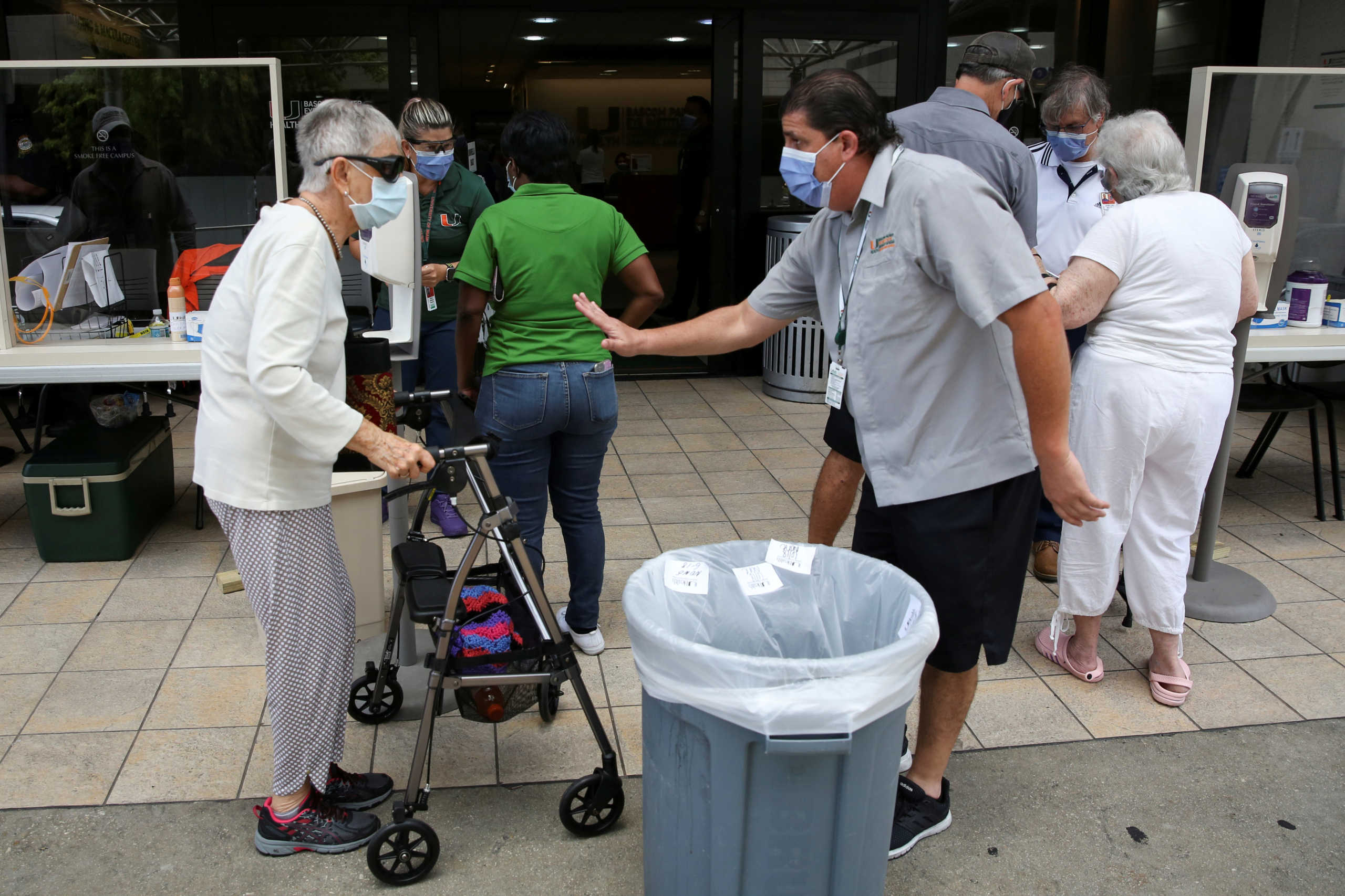 People wait for a health assessment check-in before entering Jackson Memorial Hospital, as Miami-Dade County eases some of the lockdown measures put in place during the coronavirus disease (COVID-19) outbreak, in Miami, Florida, U.S., June 18, 2020. REUTERS