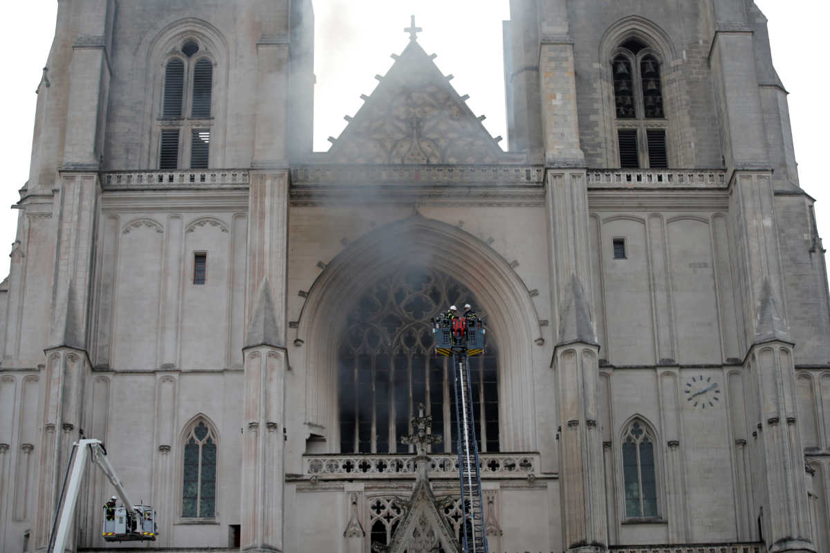 French firefighters battle a blaze at the Cathedral of Saint Pierre and Saint Paul in Nantes, France, July 18, 2020. REUTERS