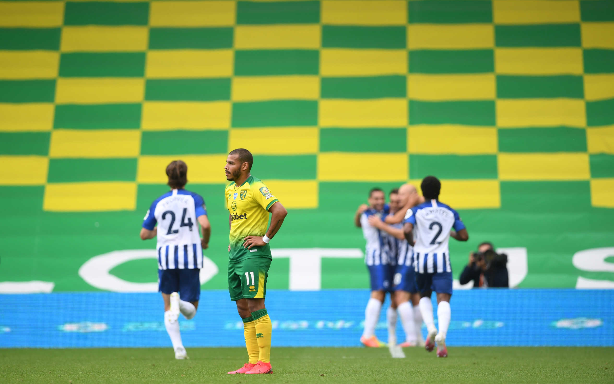 Soccer Football - Premier League - Norwich City v Brighton & Hove Albion - Carrow Road, Norwich, Britain - July 4, 2020 Norwich City's Onel Hernandez reacts as Brighton & Hove Albion's Leandro Trossard celebrates scoring their first goal with teammates, as play resumes behind closed doors following the outbreak of the coronavirus disease (COVID-19) Joe Giddens