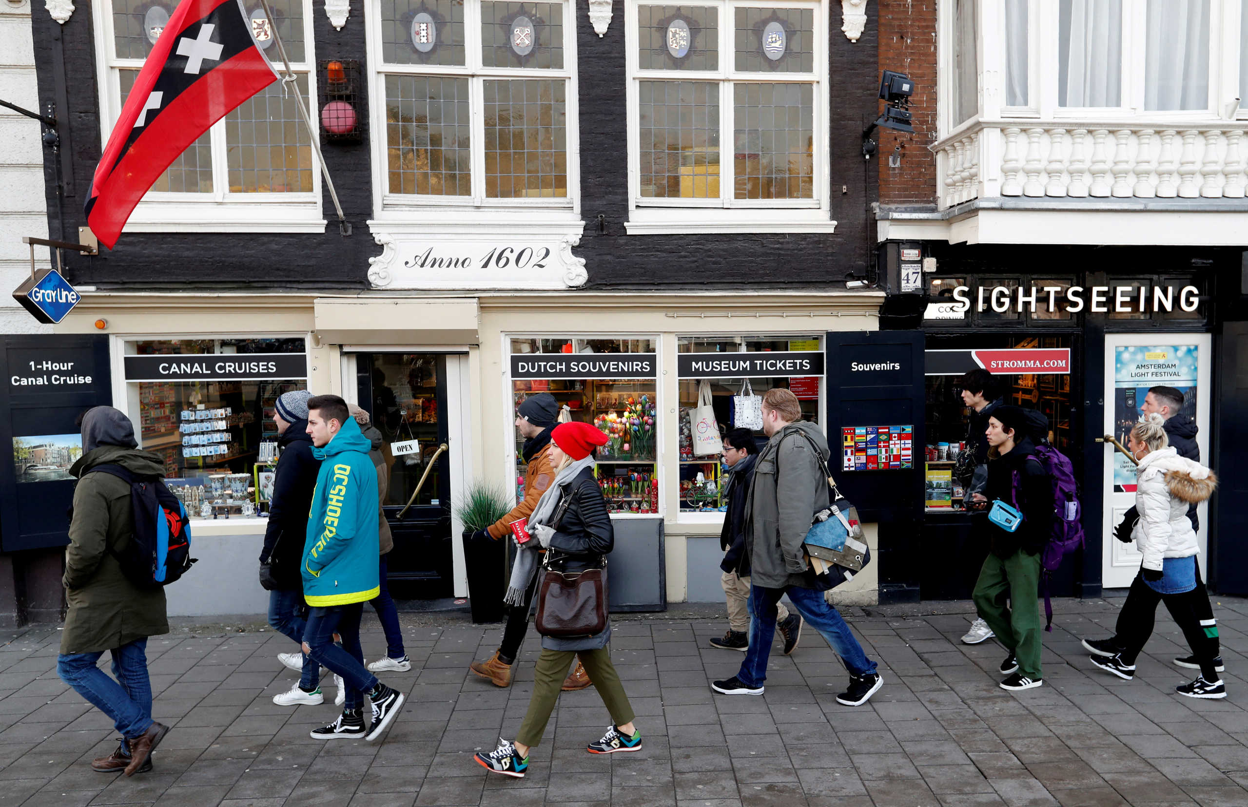 FILE PHOTO: People walk past a touristic shop in central Amsterdam, Netherlands, December 1, 2017.  REUTERS