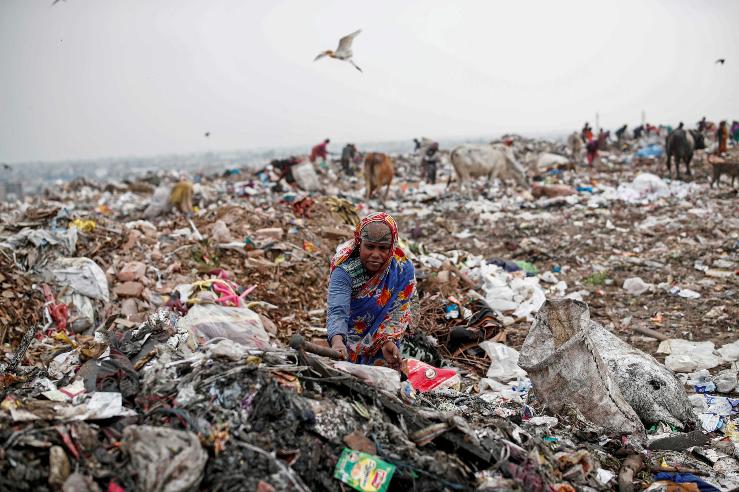 Latifa Bibi, 38, who is married to Mansoor Khan, a waste collector, looks for recyclable materials at a landfill site, during the coronavirus disease (COVID-19) outbreak, in New Delhi, India, July 16, 2020. "When I return from there, I feel afraid to enter my house because I have children at home. We are really afraid of this disease," said Bibi. REUTERS