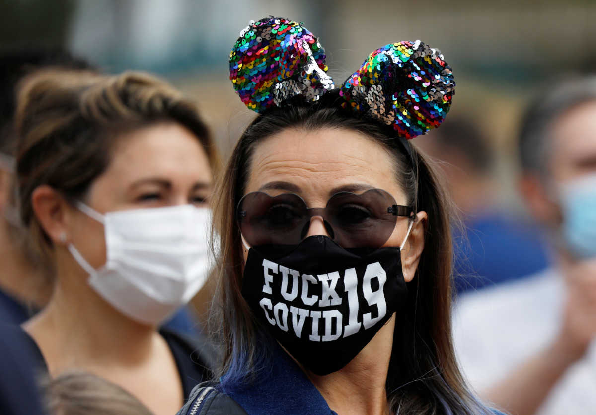 Visitors wear protective face masks at Disneyland Paris as the theme park reopens its doors to the public in Marne-la-Vallee, near Paris, following the coronavirus disease (COVID-19) outbreak in France, July 15, 2020.   REUTERS