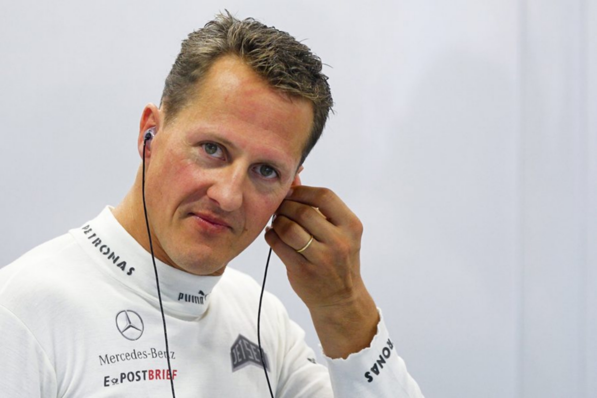 epa04392383 (FILE) A file picture dated 21 September 2012 shows German Formula One driver Michael Schumacher adjusting his earpiece before the first practice session at the Marina Bay Street Circuit in Singapore.  Record Formula One world champion Michael Schumacher will continue his recovery at home from injuries suffered in a ski accident late last year, his management said 09 September 2014. The German seven-time Formula One champion fell and hit his head on a rock while skiing in Meribel resort on December 29. He underwent two operations before being placed in an induced coma, from which doctors at Grenoble University Hospital Centre began slowing waking him in late January  EPA
