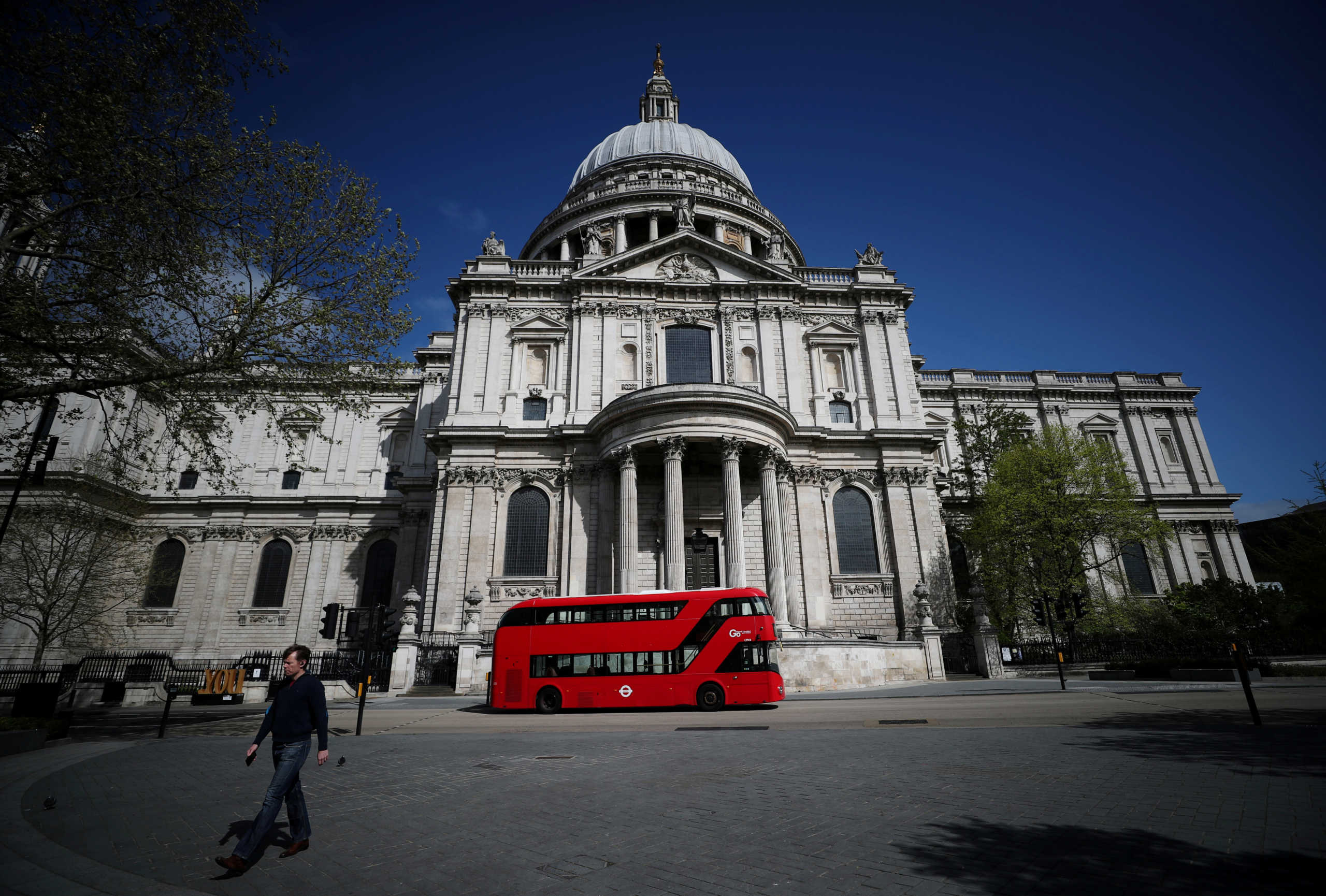 FILE PHOTO: A bus is seen outside of St. Paul's Cathedral, London, Britain, April 13, 2020. REUTERS