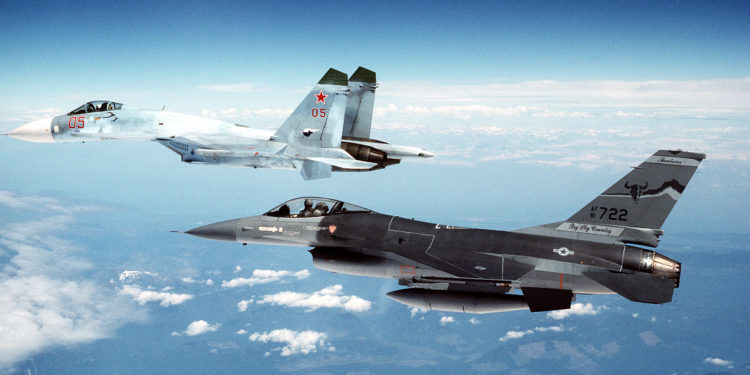 An F-16A Fighting Falcon aircraft from the 186th Fighter Interceptor Squadron, Montana Air National Guard, escorts a Soviet Su-27 Flanker aircraft to the Canadian border after an air show.