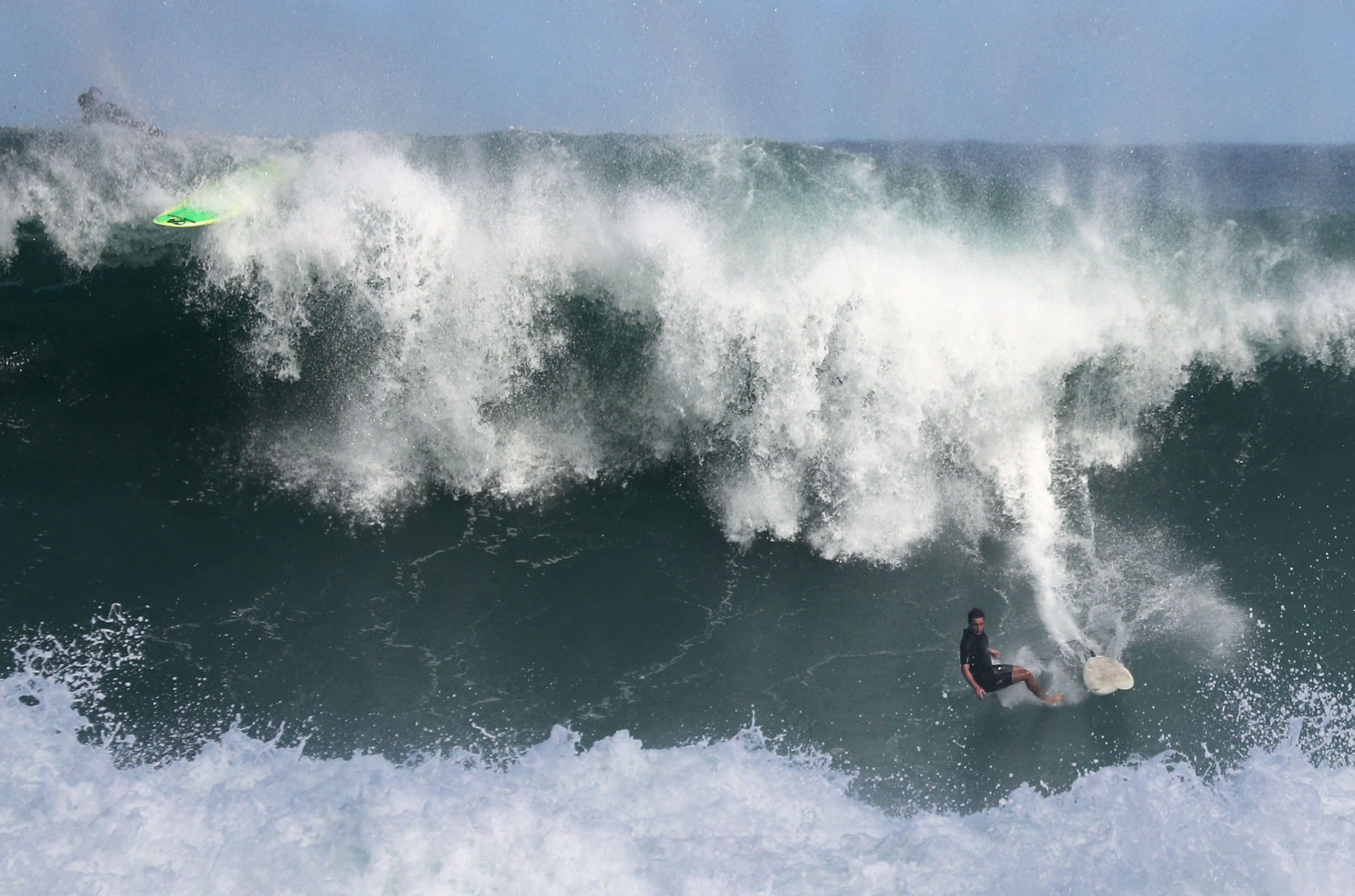 A surfer falls off a wave on a Leblon beach swell, amid the coronavirus disease (COVID-19) outbreak in Rio de Janeiro, Brazil July 2, 2020. REUTERS