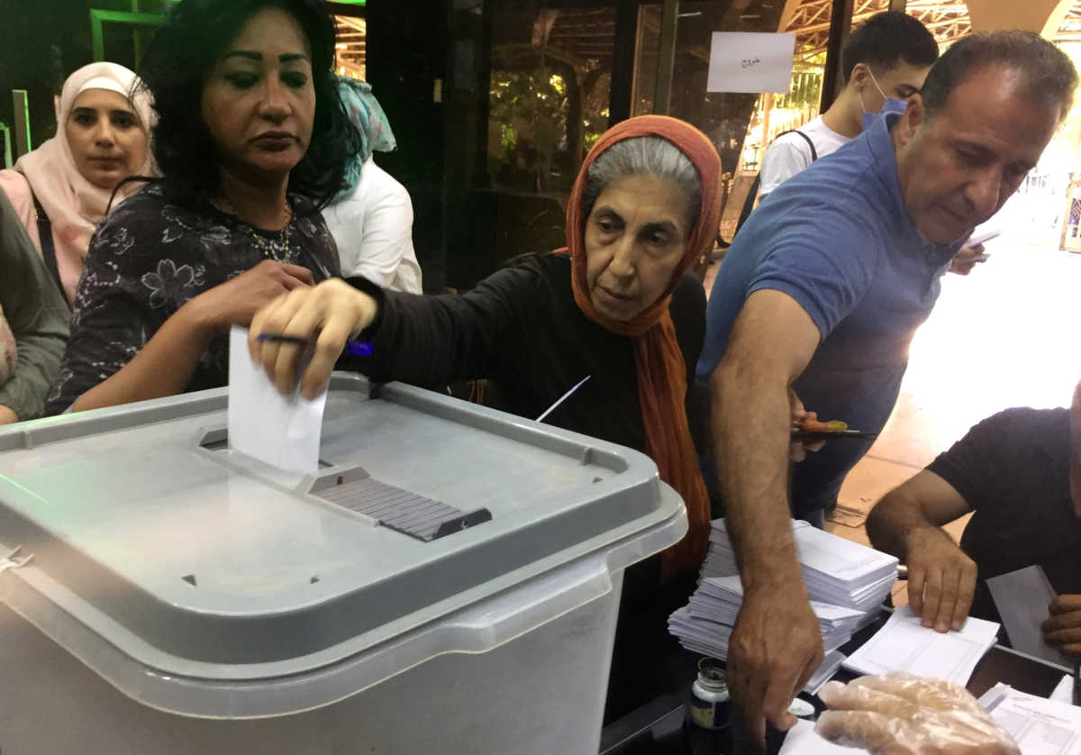 A woman casts her vote inside a polling station during the parliamentary elections in Damascus, Syria July 19, 2020. REUTERS