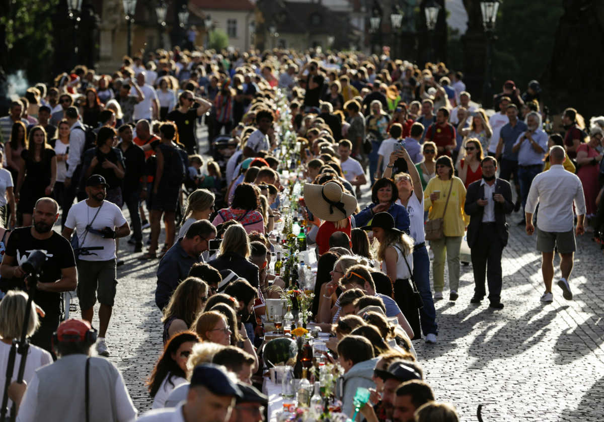 Residents dine at a 500-metre-long table spanning across the length of the medieval Charles Bridge as restrictions ease following the coronavirus disease (COVID-19) outbreak, in Prague, Czech Republic June 30, 2020. REUTERS