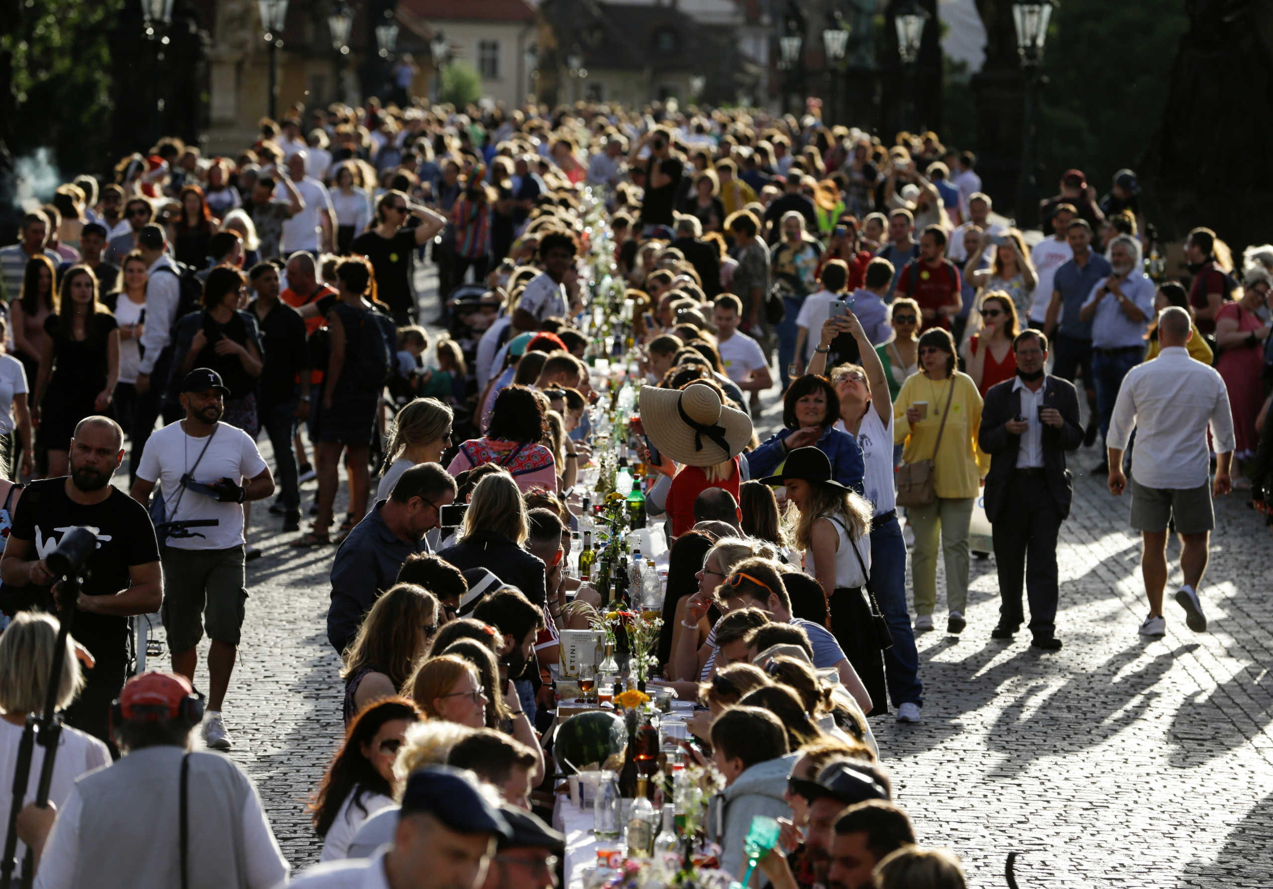 Residents dine at a 500-metre-long table spanning across the length of the medieval Charles Bridge as restrictions ease following the coronavirus disease (COVID-19) outbreak, in Prague, Czech Republic June 30, 2020. REUTERS