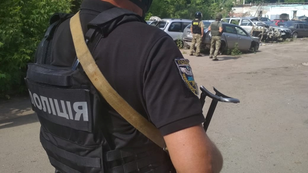 Ukrainian law enforcement officers are seen near a site where a man armed with a grenade holds a policeman hostage in Poltava, Ukraine July 23, 2020. Press Service of the National Police of Ukraine