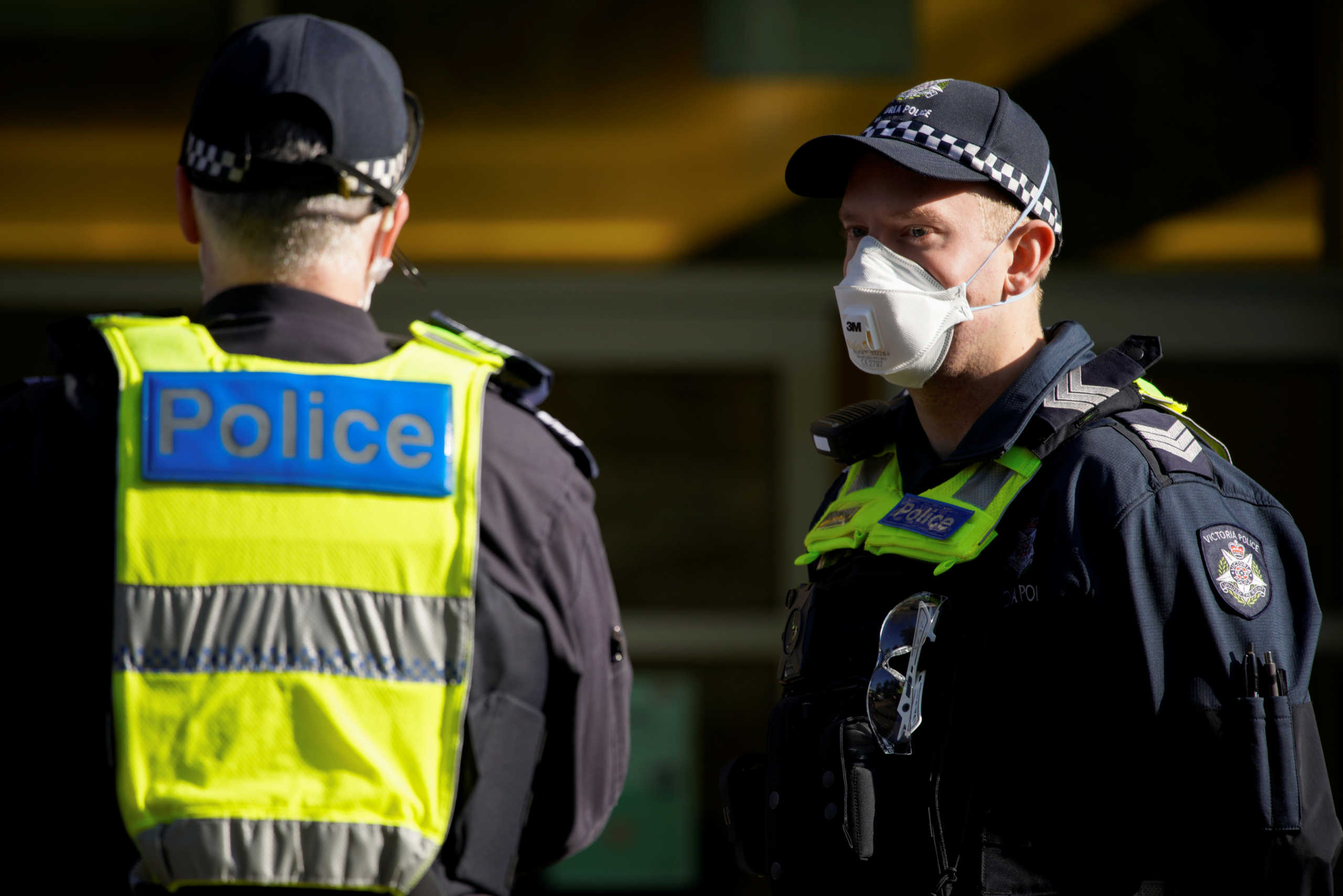 Victoria Police officers meet outside a public housing tower, locked down in response to an outbreak of the coronavirus disease (COVID-19), in Melbourne, Australia, July 8, 2020. REUTERS