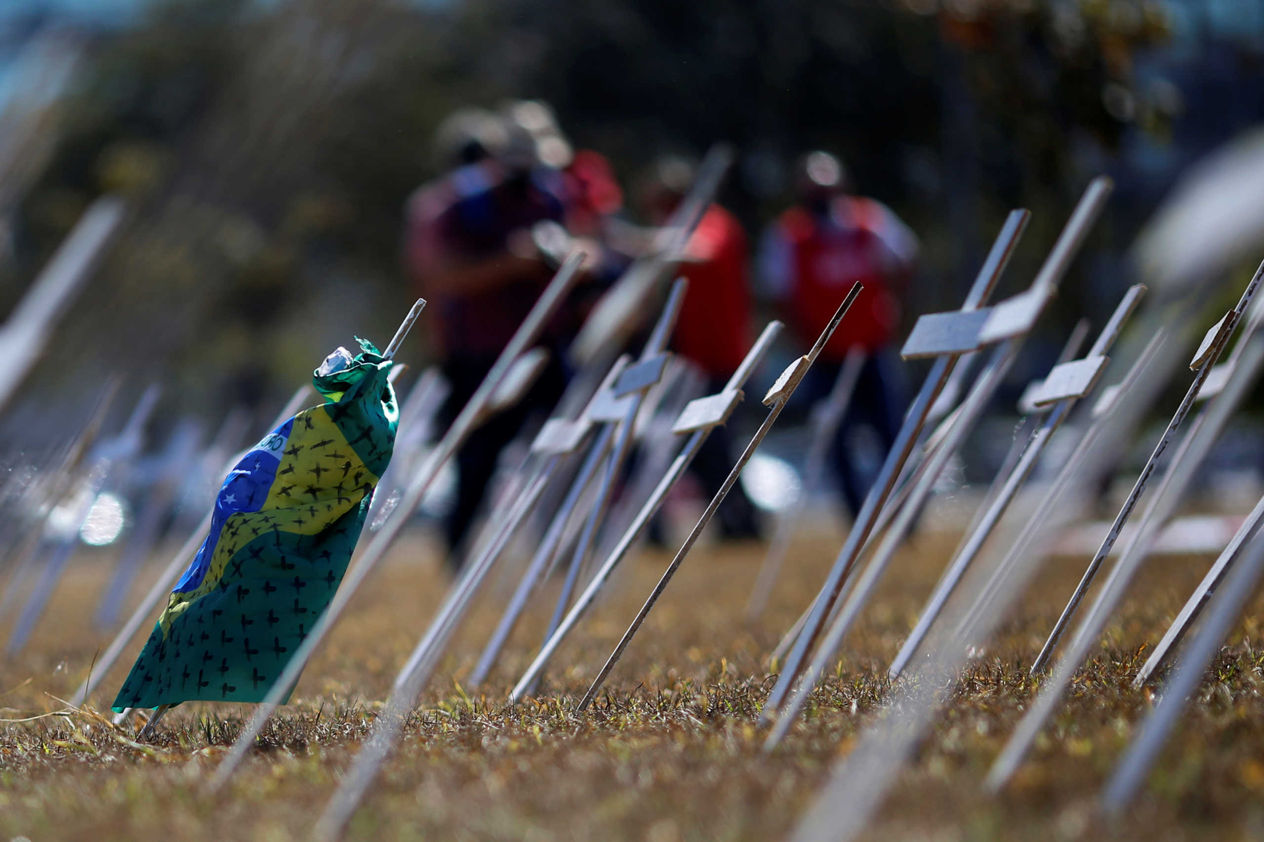 Crosses symbolising the ones who died from the coronavirus disease (COVID-19) stand in front of the National Congress during a protest against Brazil's President Jair Bolsonaro in Brasilia, Brazil July 14, 2020. REUTERS