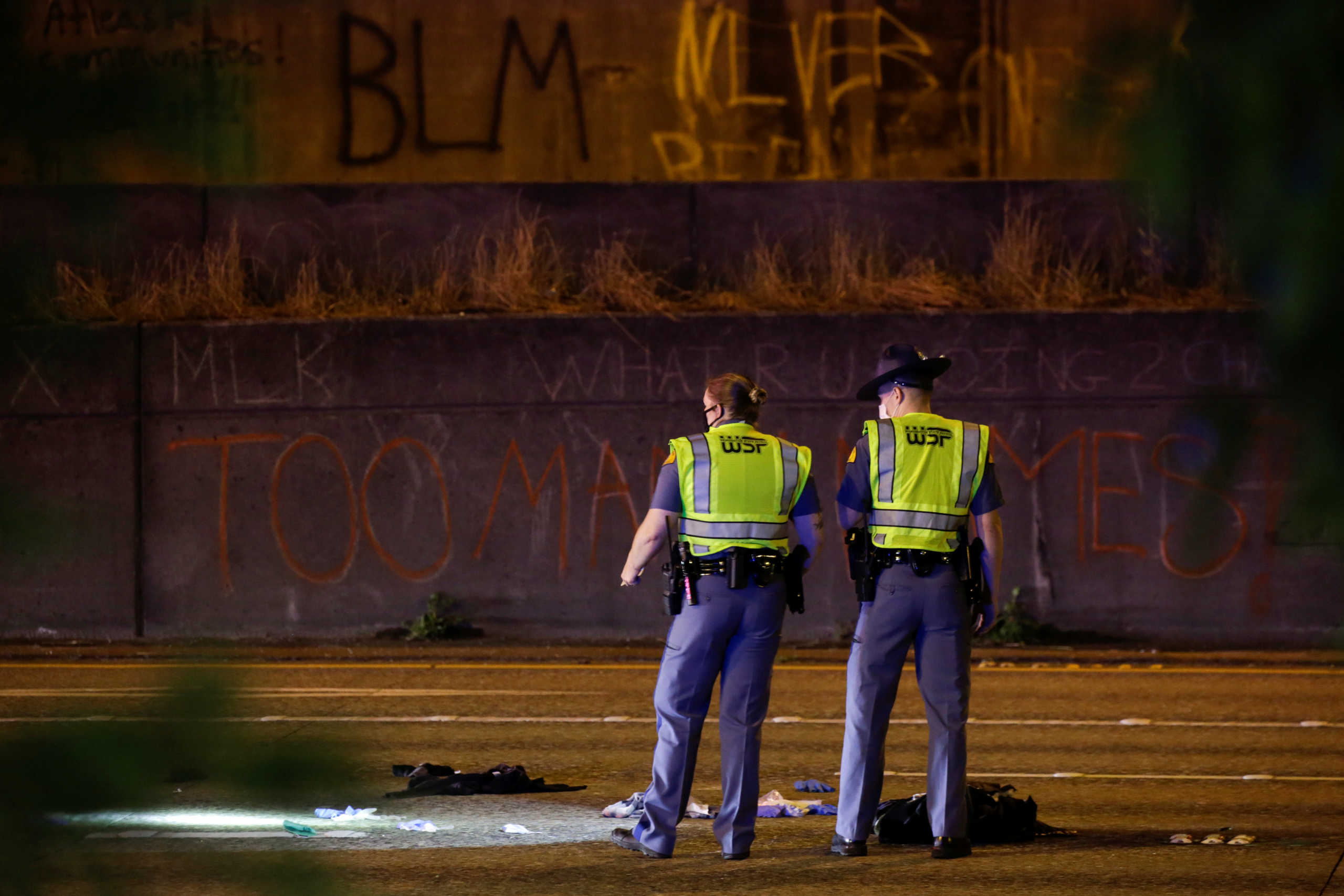 Washington State Troopers investigate the scene where two people in a group of protesters were stuck by a car on Interstate 5 while the highway was closed to traffic due to the protest in Seattle, Washington, U.S., July 4, 2020. REUTERS