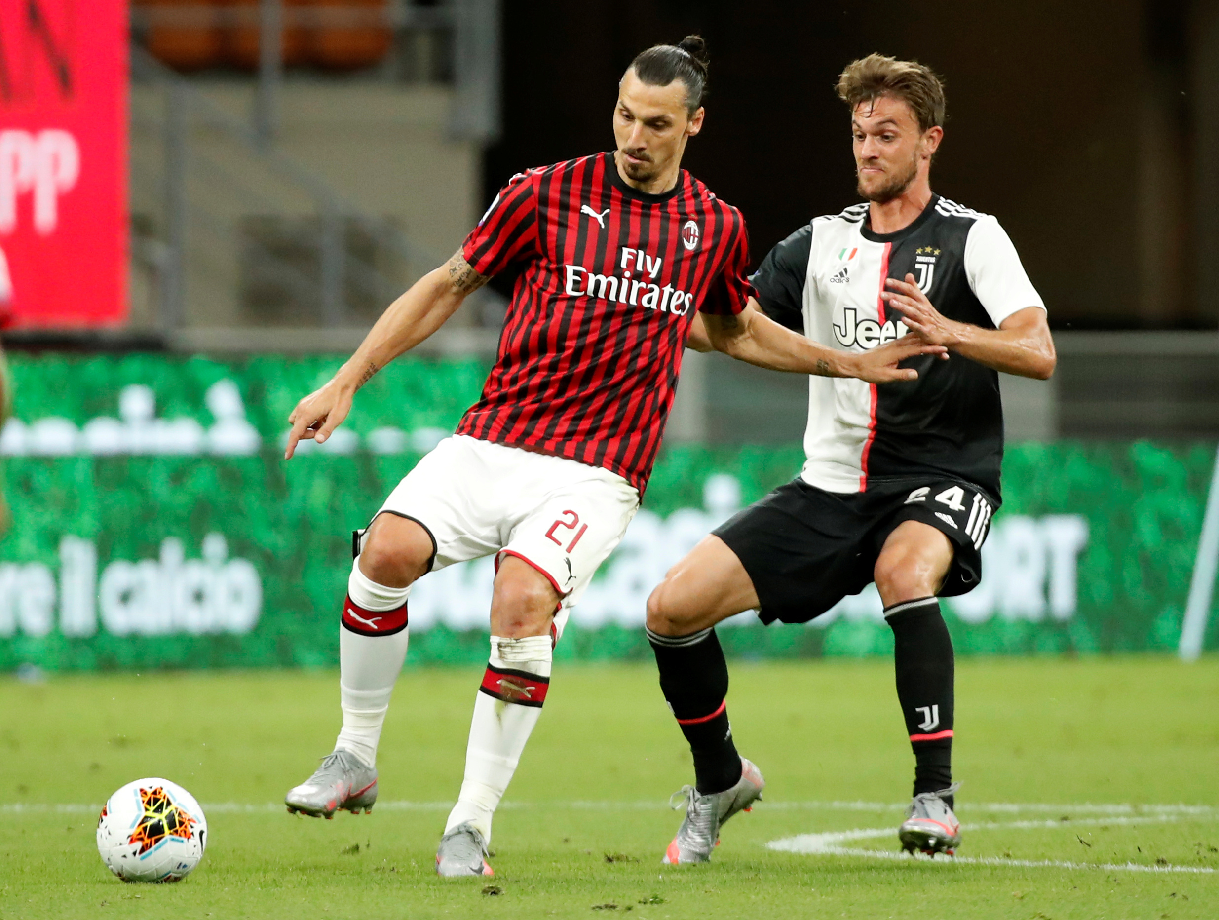 Soccer Football - Serie A - AC Milan v Juventus - San Siro, Milan, Italy - July 7, 2020   AC Milan's Zlatan Ibrahimovic in action with Juventus' Daniele Rugani, as play resumes behind closed doors following the outbreak of the coronavirus disease (COVID-19)   REUTERS
