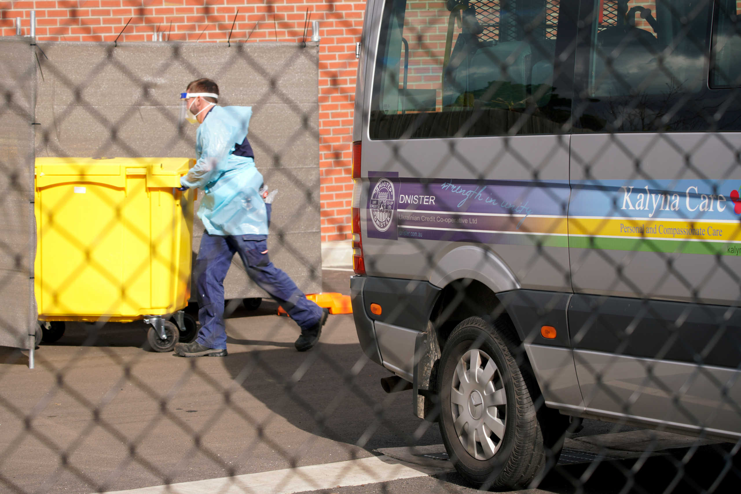 Medical personnel disposes medical waste outside the Kalyna Aged Care facility amid the second wave of the coronavirus disease (COVID-19) in Melbourne, Australia August 17, 2020. REUTERS
