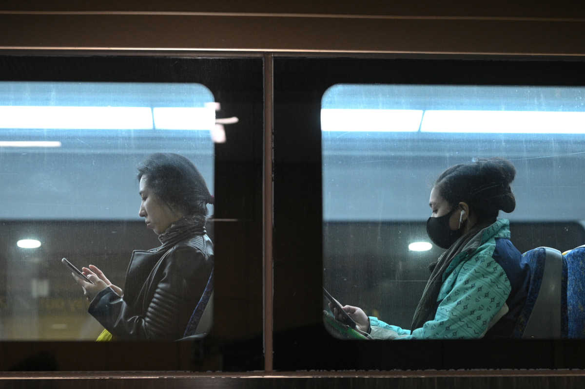 Commuters ride a train as the state of New South Wales continues to report low numbers for new daily cases of the coronavirus disease (COVID-19) in Sydney, Australia, August 19, 2020.  REUTERS