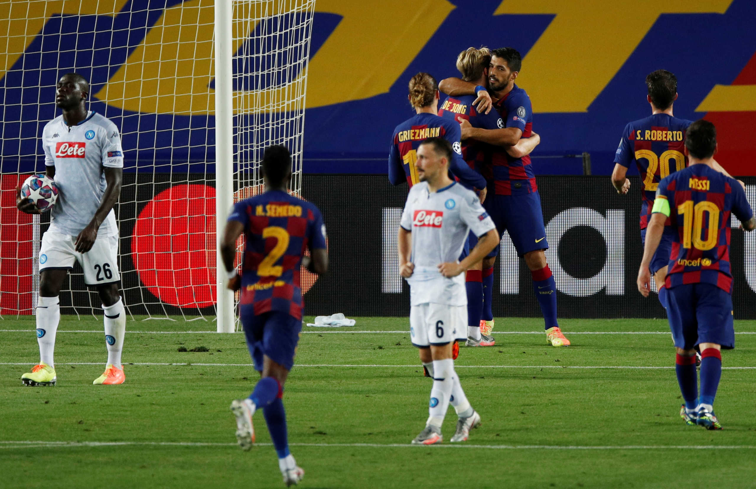 Soccer Football - Champions League - Round of 16 Second Leg - FC Barcelona v Napoli - Camp Nou, Barcelona, Spain - August 8, 2020  Barcelona's Luis Suarez celebrates scoring their third goal with teammates, as play resumes behind closed doors following the outbreak of the coronavirus disease (COVID-19)  REUTERS
