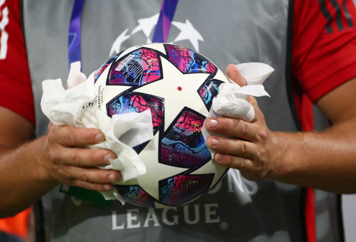 Soccer Football - Champions League - Round of 16 Second Leg - Bayern Munich v Chelsea - Allianz Arena, Munich, Germany - August 8, 2020  A staff member disinfects a ball before the match, as play resumes behind closed doors following the outbreak of the coronavirus disease (COVID-19)  REUTERS