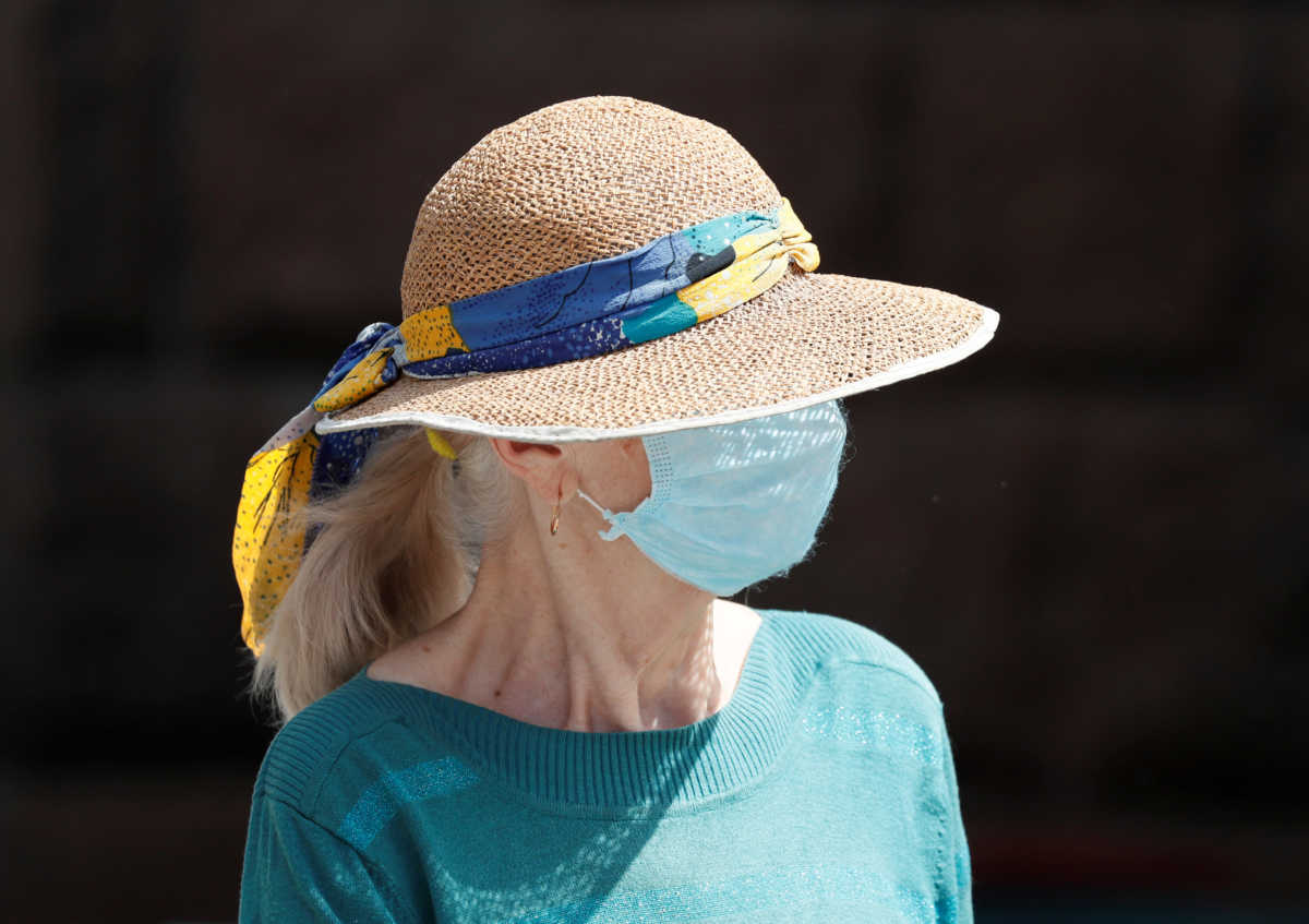 A woman wearing a protective face mask is seen on the street amid the outbreak of the coronavirus disease (COVID-19) in central Kiev, Ukraine June 9, 2020. REUTERS