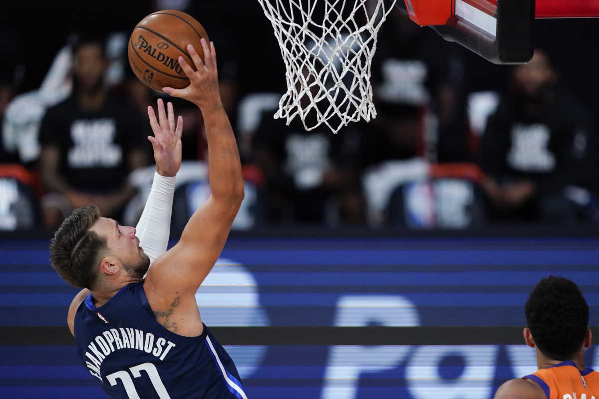 Aug 2, 2020; Lake Buena Vista, USA; Dallas Mavericks guard Luka Doncic (77) puts up a shot against the Phoenix Suns during the first half of an NBA basketball game Sunday, Aug. 2, 2020, in Lake Buena Vista, Fla. Mandatory Credit: Ashley Landis