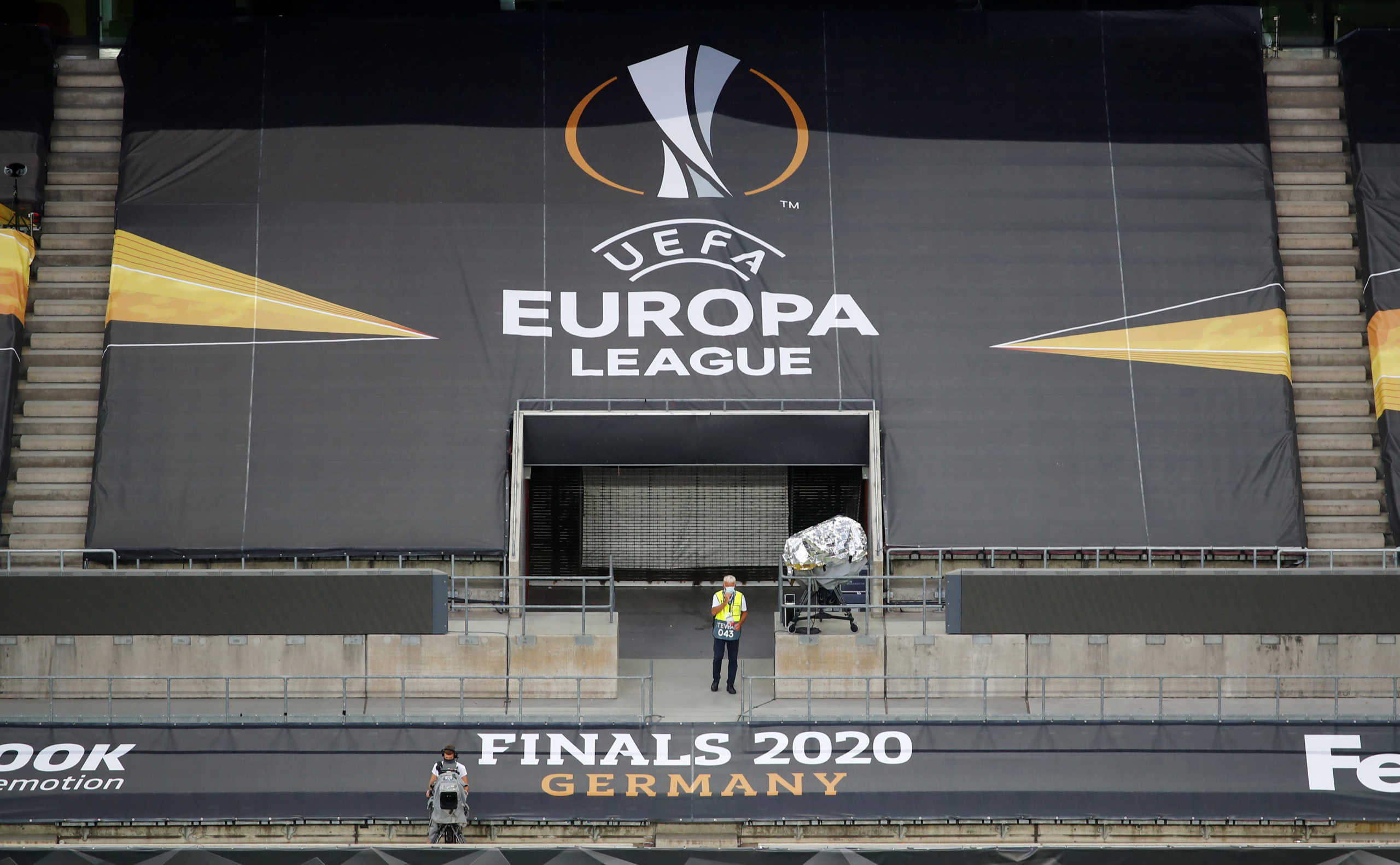Soccer Football - Europa League - Manchester United Training - RheinEnergieStadion, Cologne, Germany - August 9, 2020  A steward and TV cameraman in the stands during training  Wolfgang Rattay