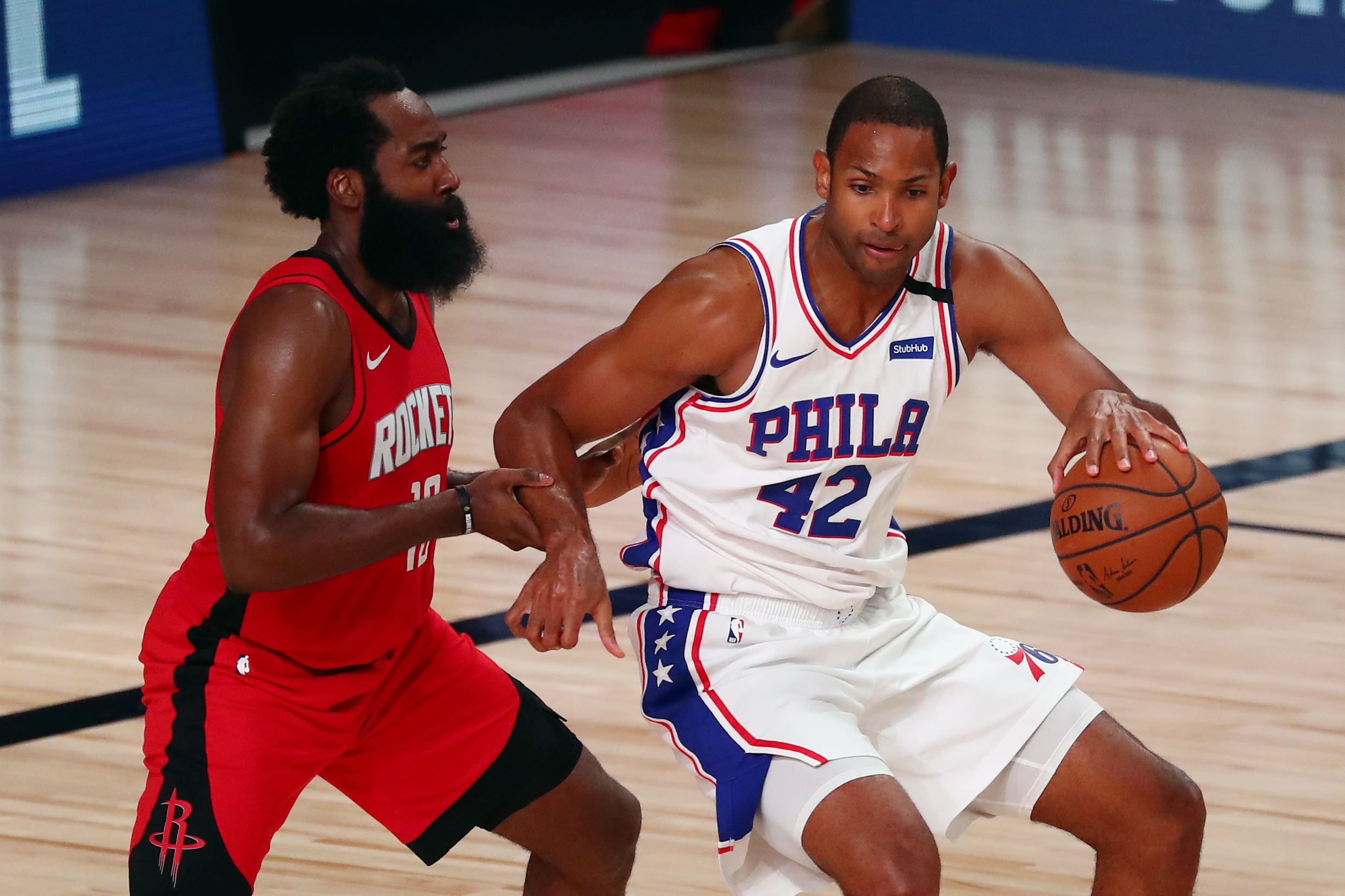 Aug 14, 2020; Lake Buena Vista, Florida, USA; Philadelphia 76ers forward Al Horford (42) drives against Houston Rockets guard James Harden (left) during the second half of a NBA basketball game at AdventHealth Arena. Mandatory Credit: Kim Klement-USA TODAY Sports