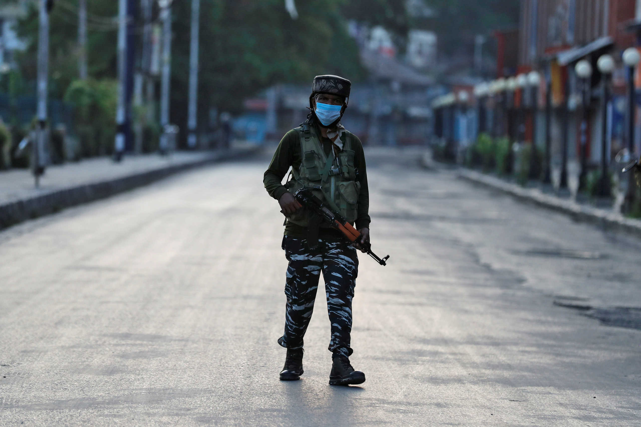 An Indian Central Reserve Police Force (CRPF) officer patrols on an empty street during a lockdown on the first anniversary of the revocation of Kashmir's autonomy, in Srinagar August 5, 2020. REUTERS