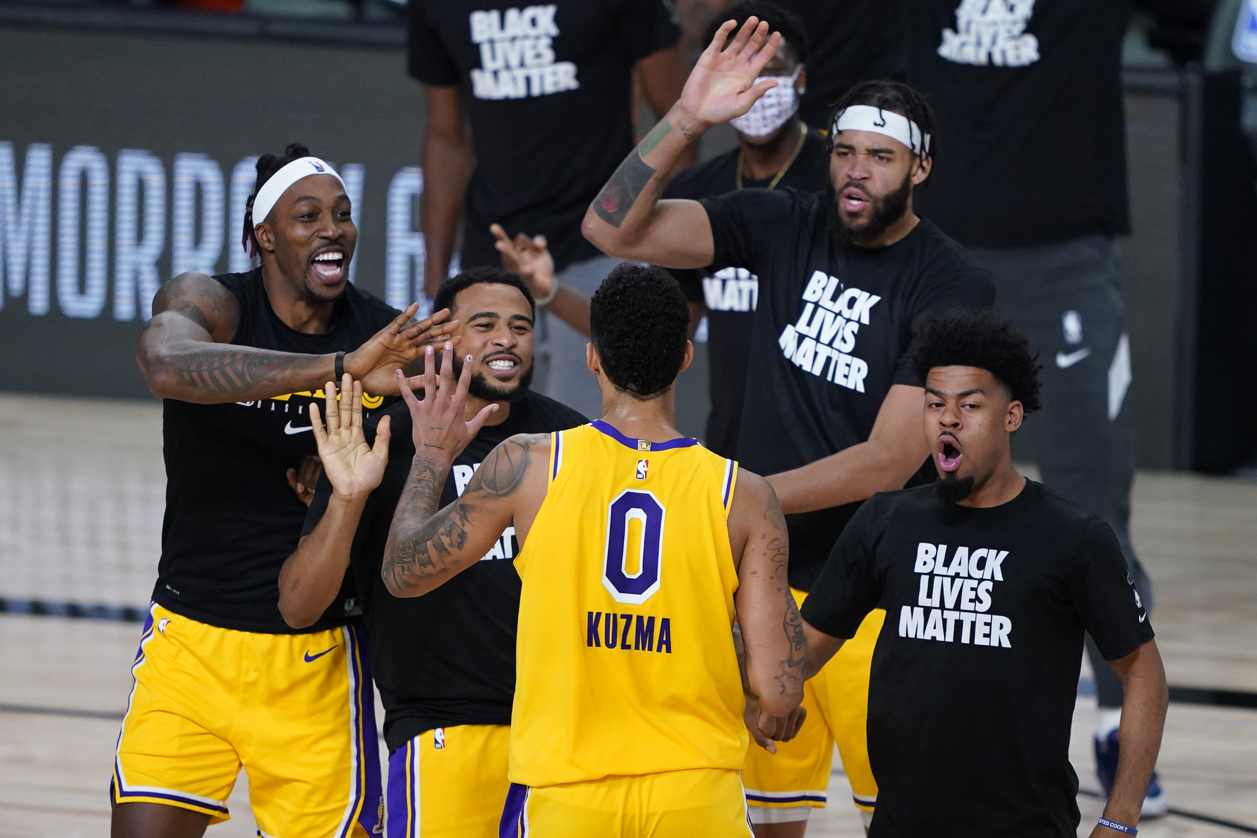 Aug 10, 2020; Lake Buena Vista, Florida, USA; Los Angeles Lakers' Kyle Kuzma (0) is congratulated by teammates after hitting a game-winning 3-pointer against the Denver Nuggets during the second half of an NBA basketball game Monday, Aug. 10, 2020, in Lake Buena Vista, Fla. at AdventHealth Arena. The Lakers won 124-121. Mandatory Credit: Ashley Landis