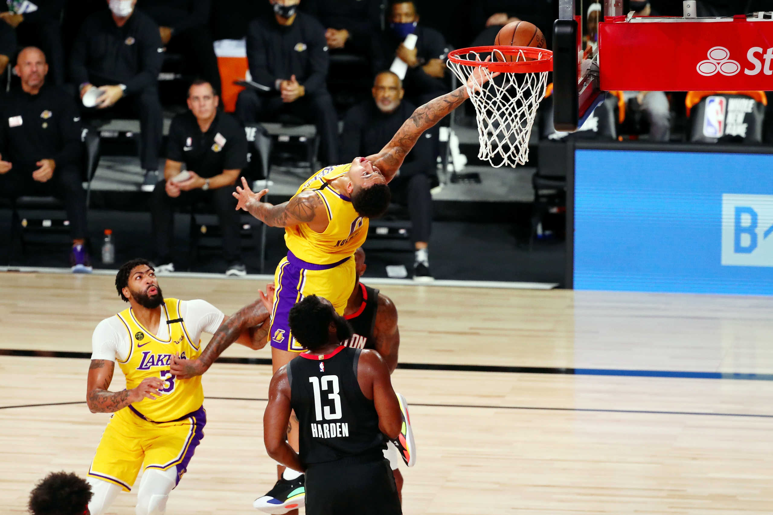 Aug 6, 2020; Lake Buena Vista, Florida, USA; Los Angeles Lakers forward Kyle Kuzma (0) takes a backwards shot against the Houston Rockets during the first half of an NBA basketball game at The Arena. Mandatory Credit: Kim Klement-USA TODAY Sports