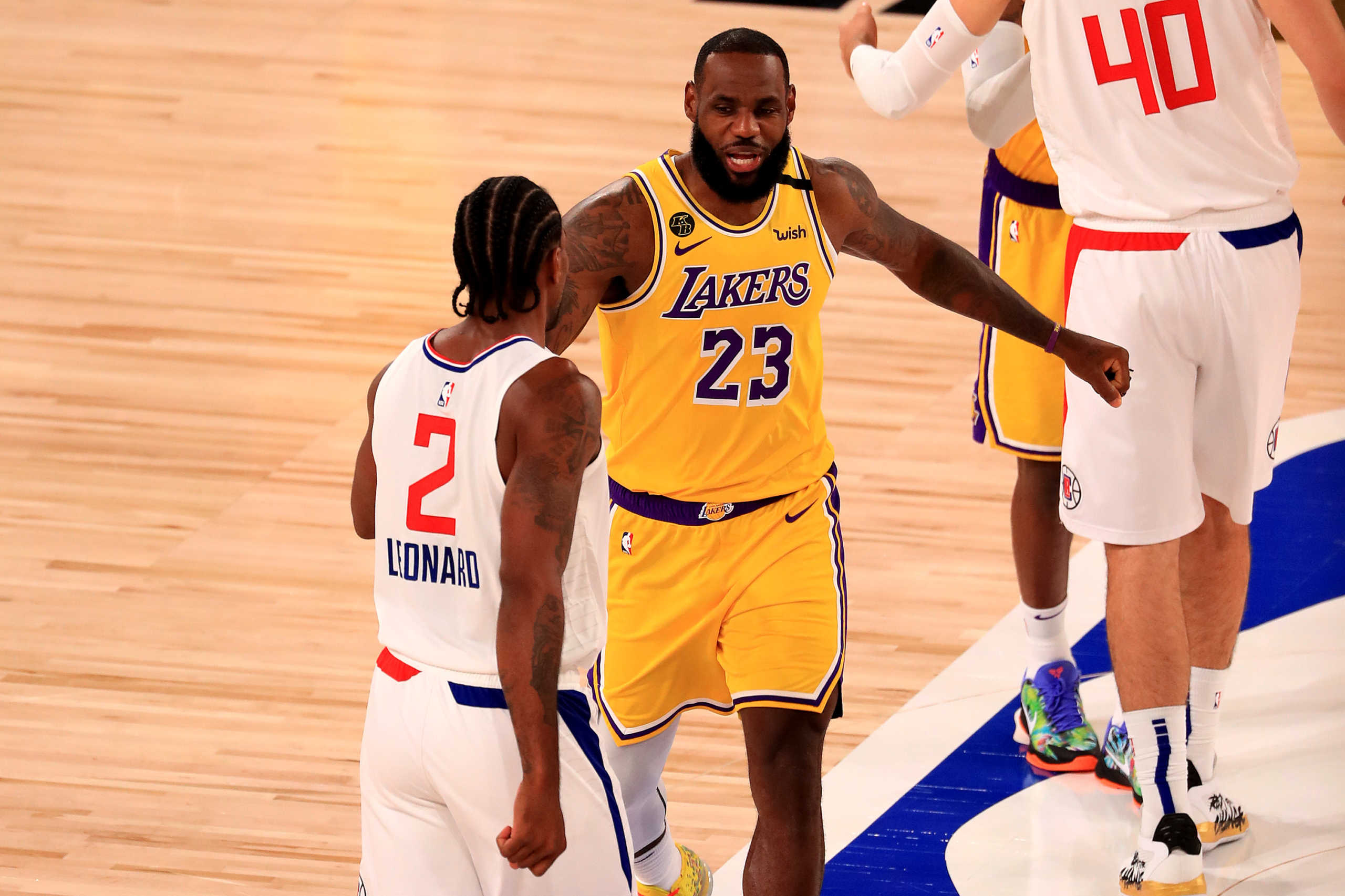 July 30, 2020; Lake Buena Vista, USA;  LeBron James #23 of the Los Angeles Lakers talks with Kawhi Leonard #2 of the LA Clippers during the first quarter of the game at The Arena at ESPN Wide World Of Sports Complex on July 30, 2020 in Lake Buena Vista, Florida.  Mandatory Credit: Mike Ehrmann