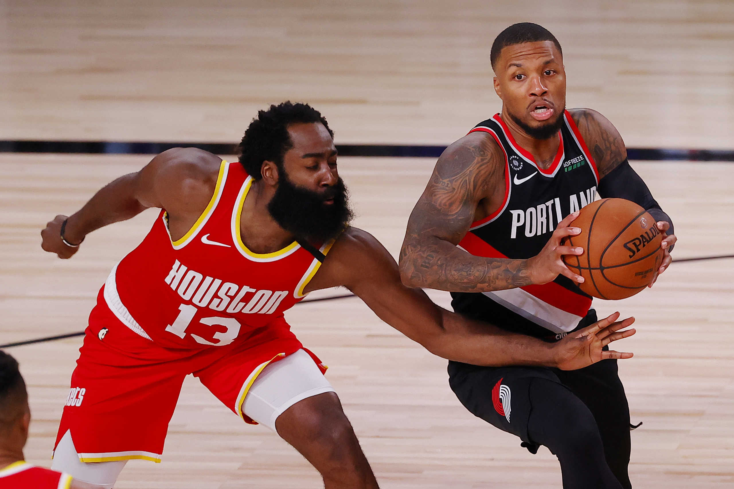 Aug 4, 2020; Lake Buena Vista, USA; Damian Lillard #0 of the Portland Trail Blazers handles the ball against James Harden #13 of the Houston Rockets during the second half at The Arena at ESPN Wide World Of Sports Complex on August 04, 2020 in Lake Buena Vista, Florida. Mandatory Credit: Kevin C. Cox